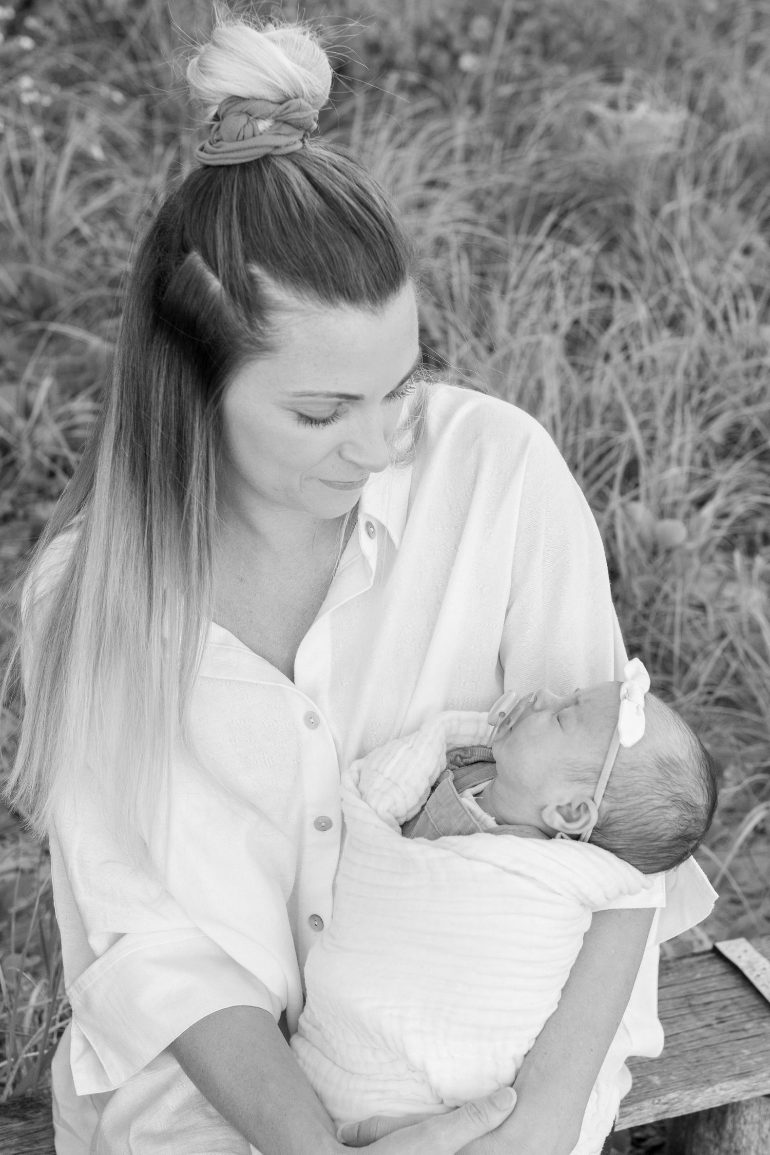 Coastal newborn session with family, featuring candid moments and gentle light.