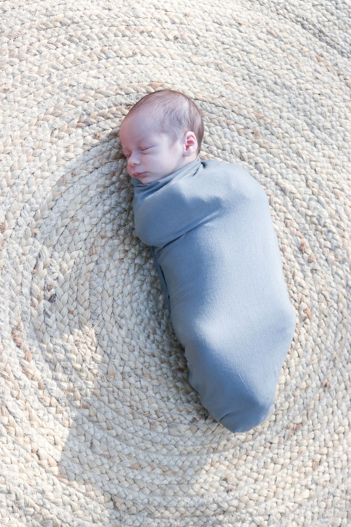 Coastal newborn session with family, featuring candid moments and gentle light.