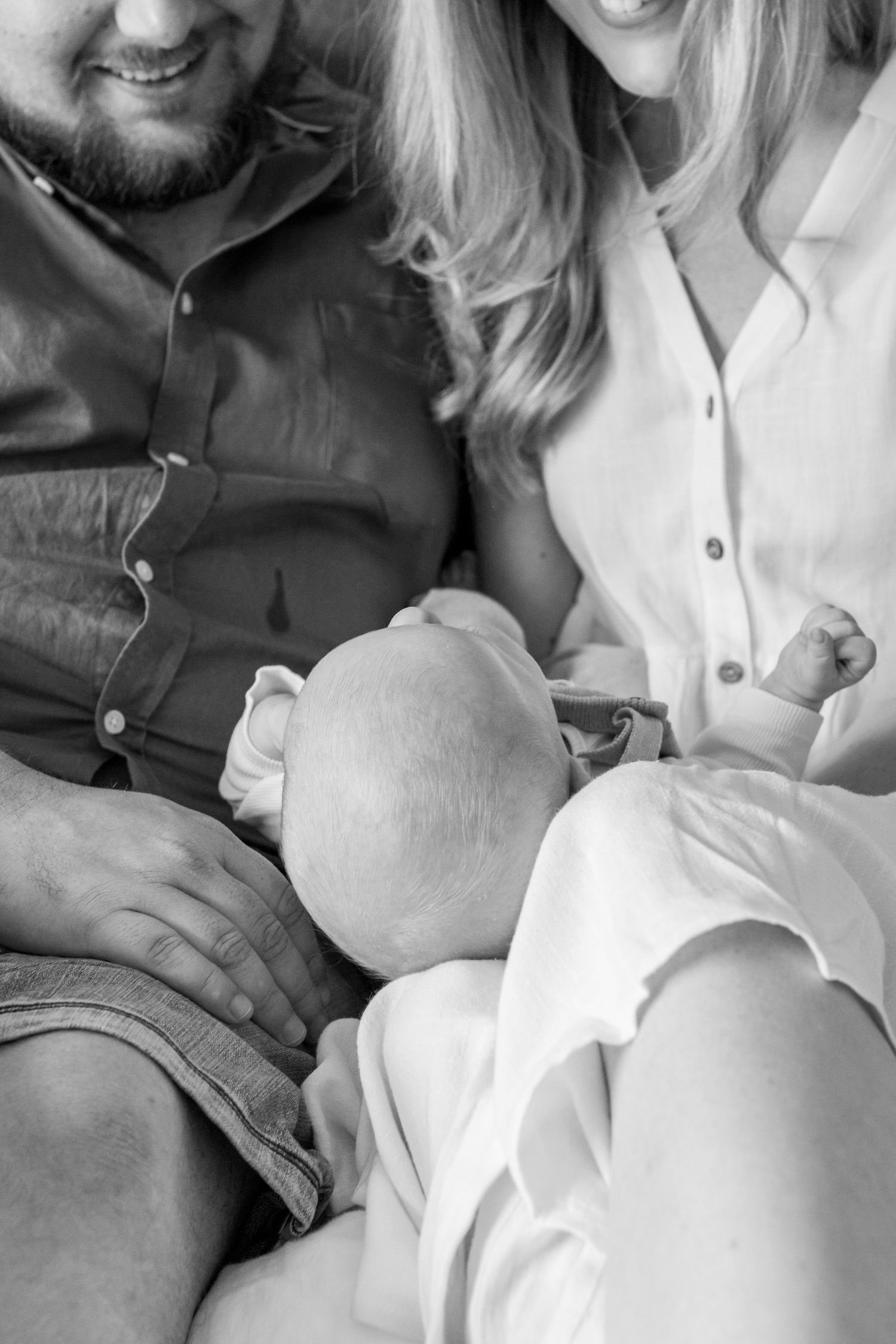 Coastal newborn session with family, featuring candid moments and gentle light.