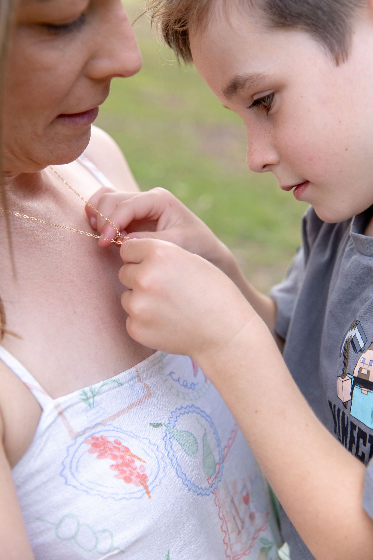 Close-up sequence showing gentle interaction between two people in a tender moment outdoors.