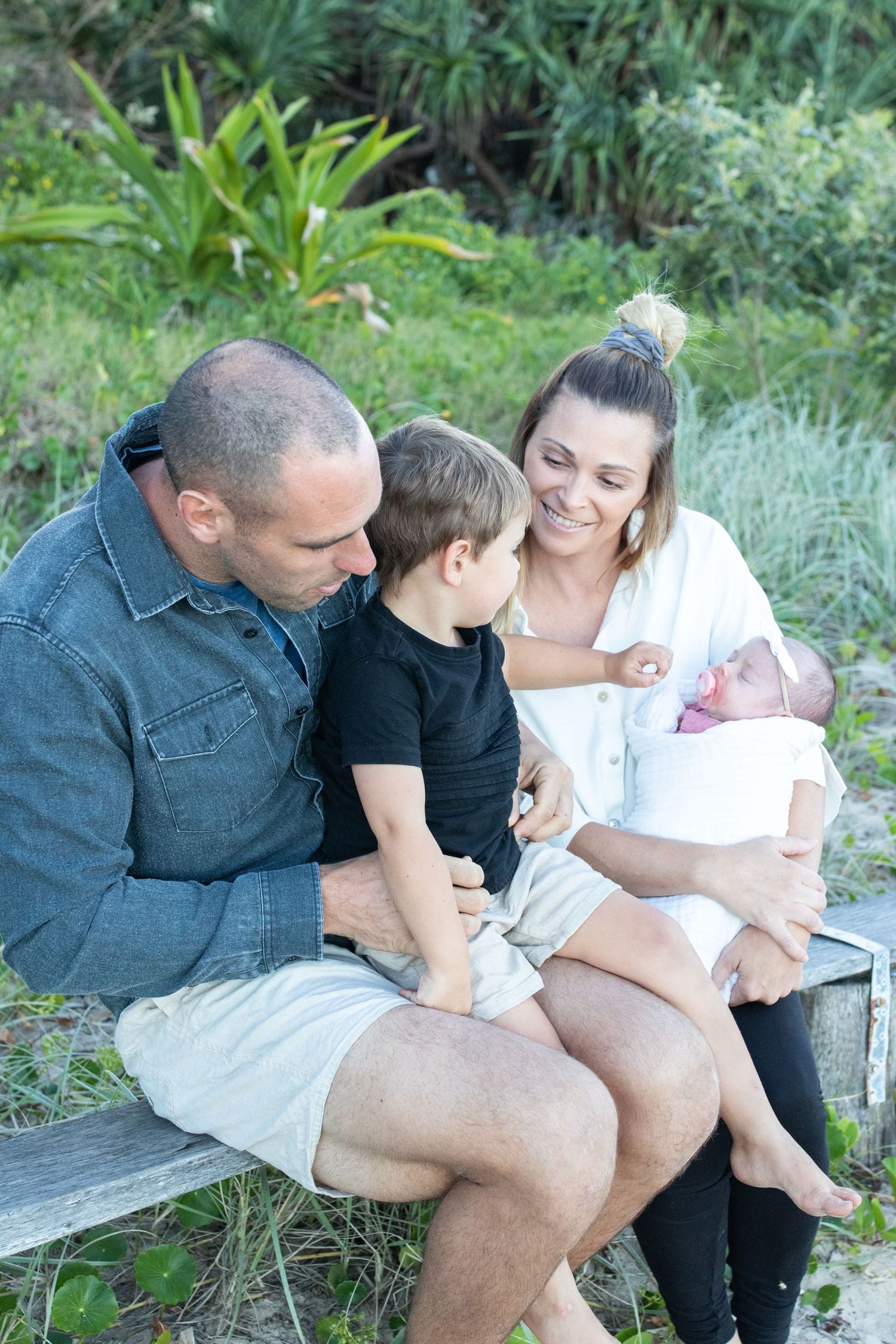 Coastal newborn session with family, featuring candid moments and gentle light.