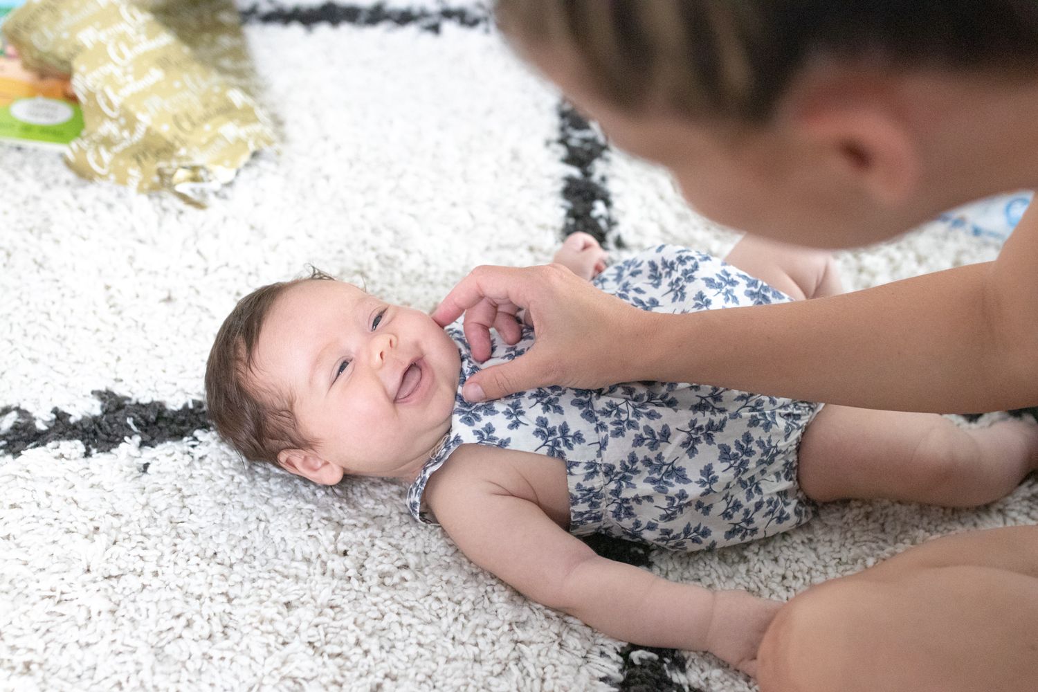 Candid photo of mum holding baby during a relaxed lifestyle session.