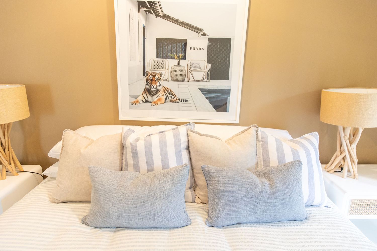 Gallery wall with black and white photographs in modern coastal-themed room.