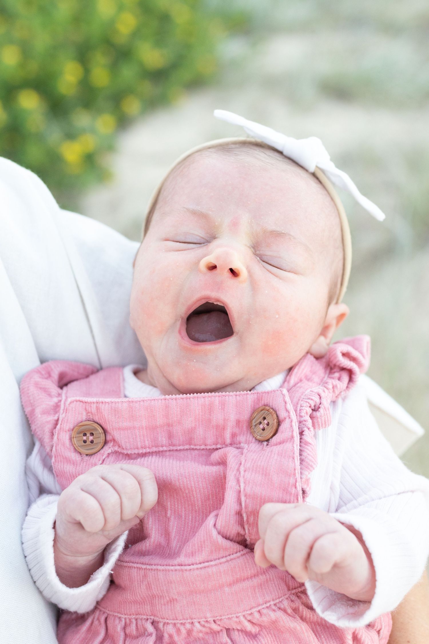 Lifestyle newborn photography at the beach, capturing gentle, coastal tones.
