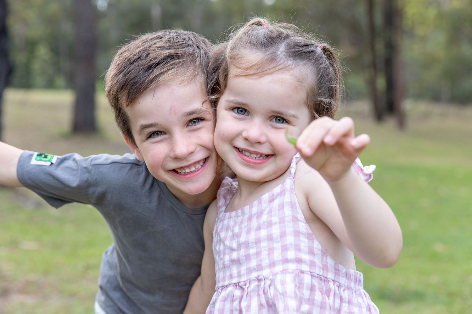 Series of joyful outdoor moments showing affectionate family interactions in a natural setting.