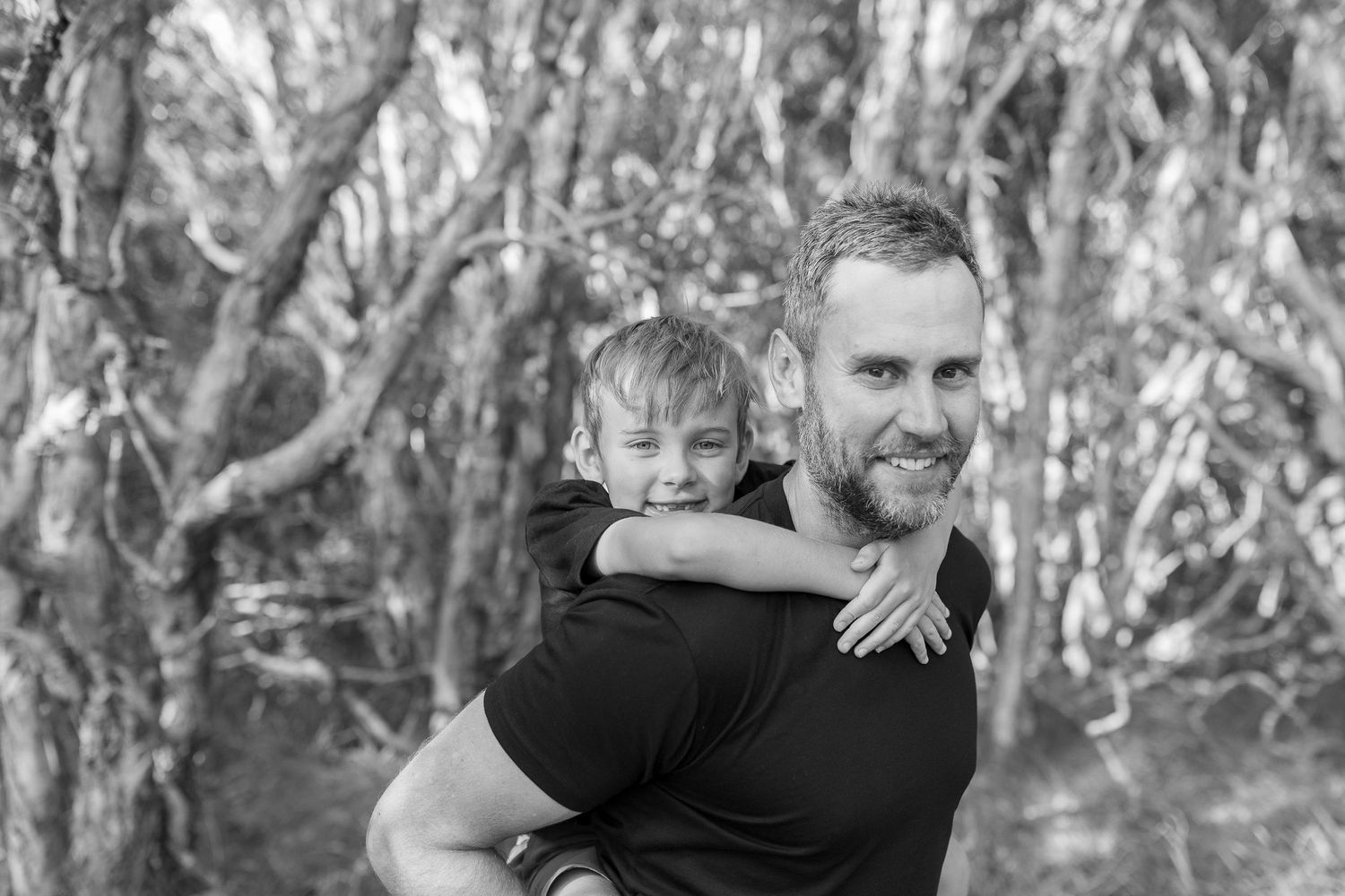 A series of candid family moments captured in a natural wooded setting.