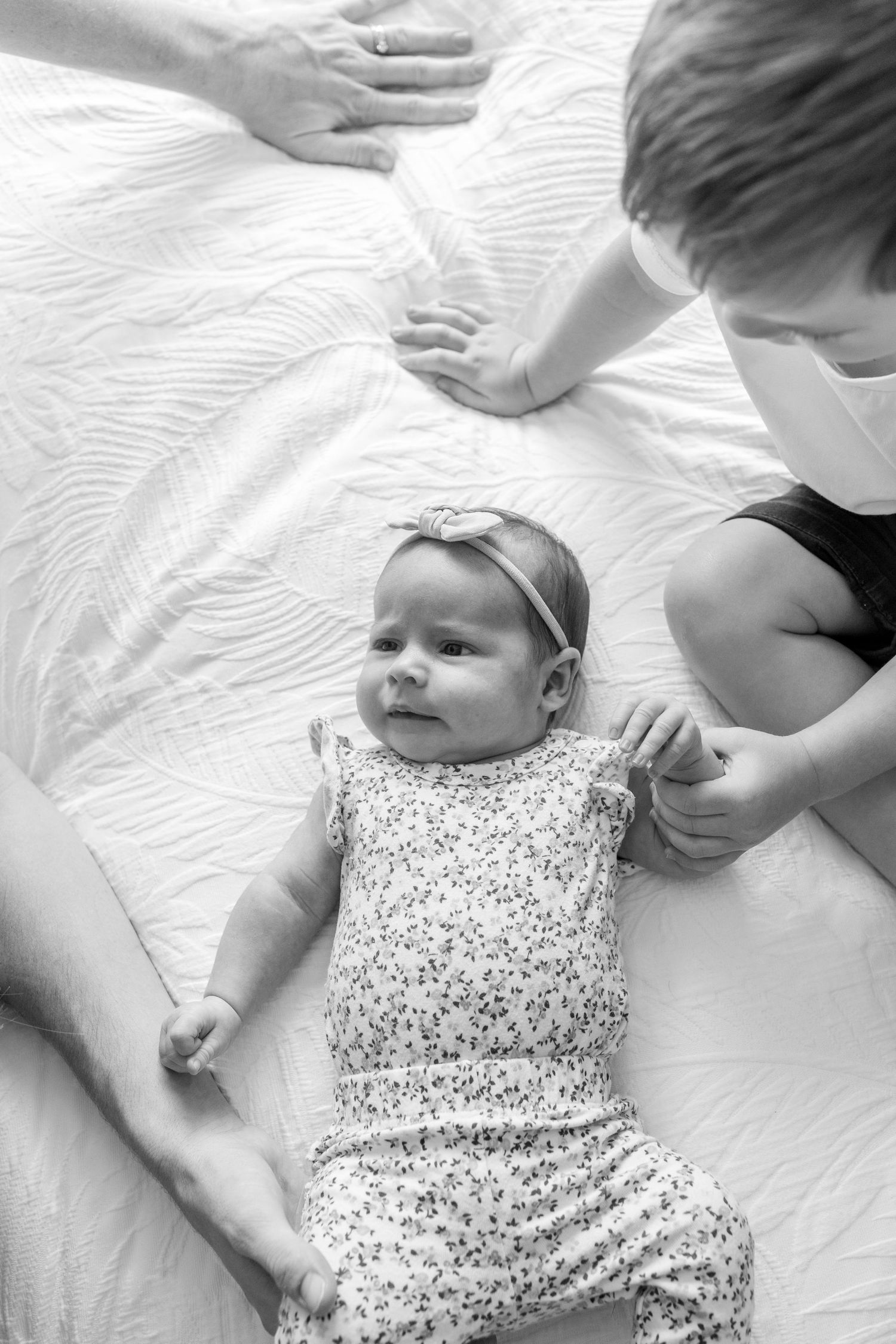 Coastal newborn session with family, featuring candid moments and gentle light.