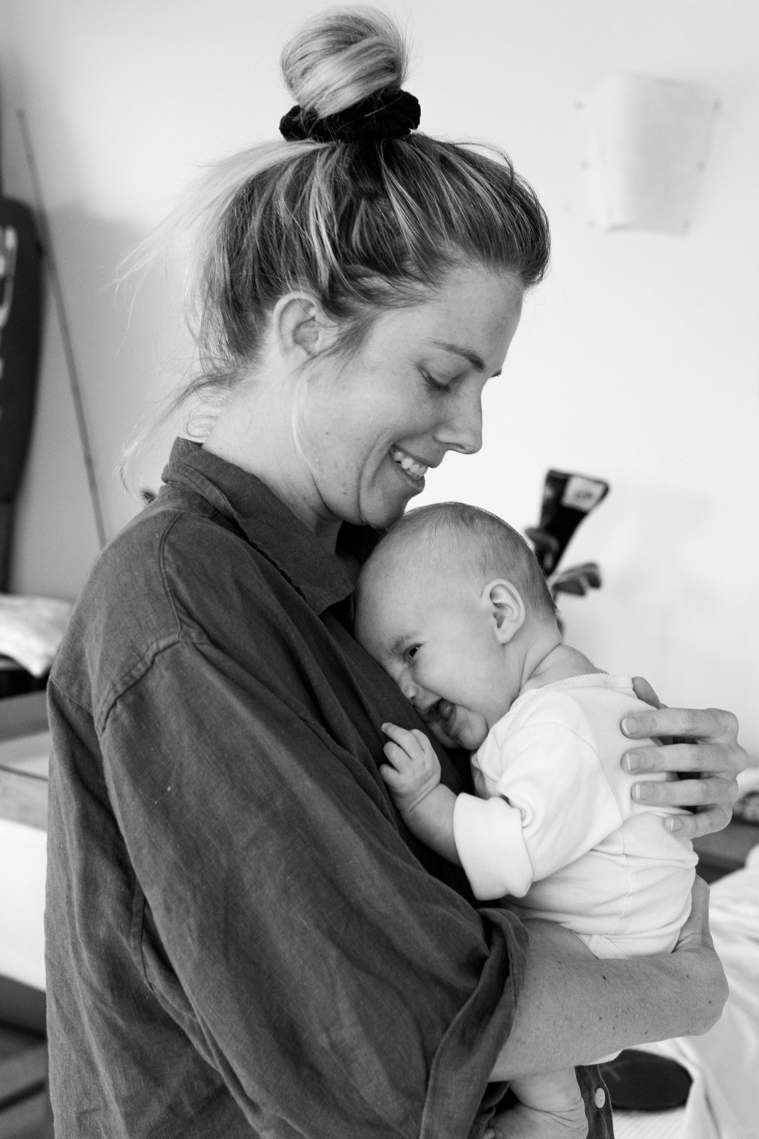 Candid photo of mum holding baby during a relaxed lifestyle session.