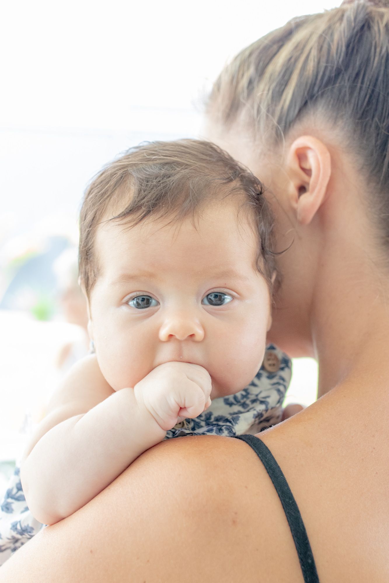 Candid photo of mum holding baby during a relaxed lifestyle session.
