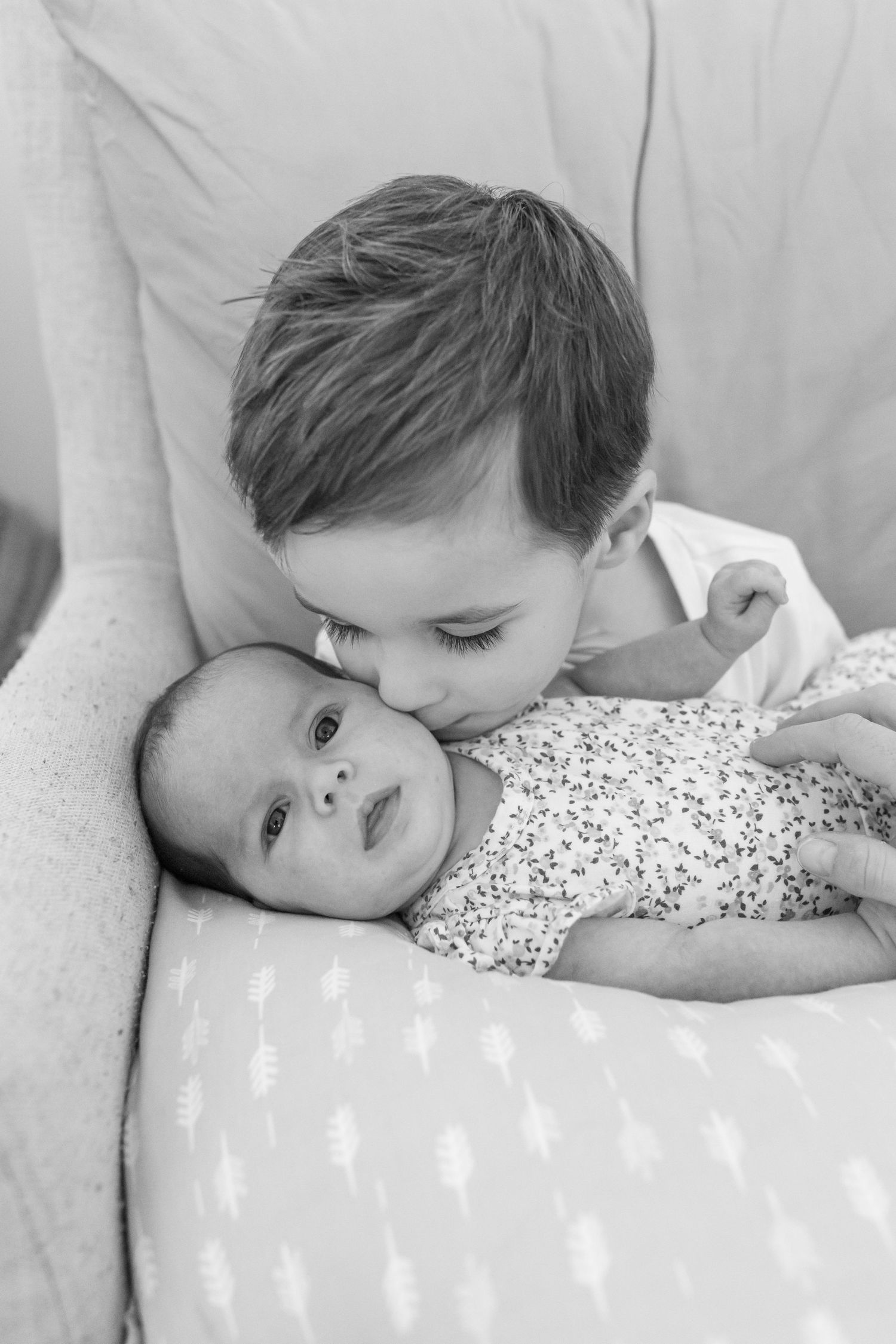 Coastal newborn session with family, featuring candid moments and gentle light.