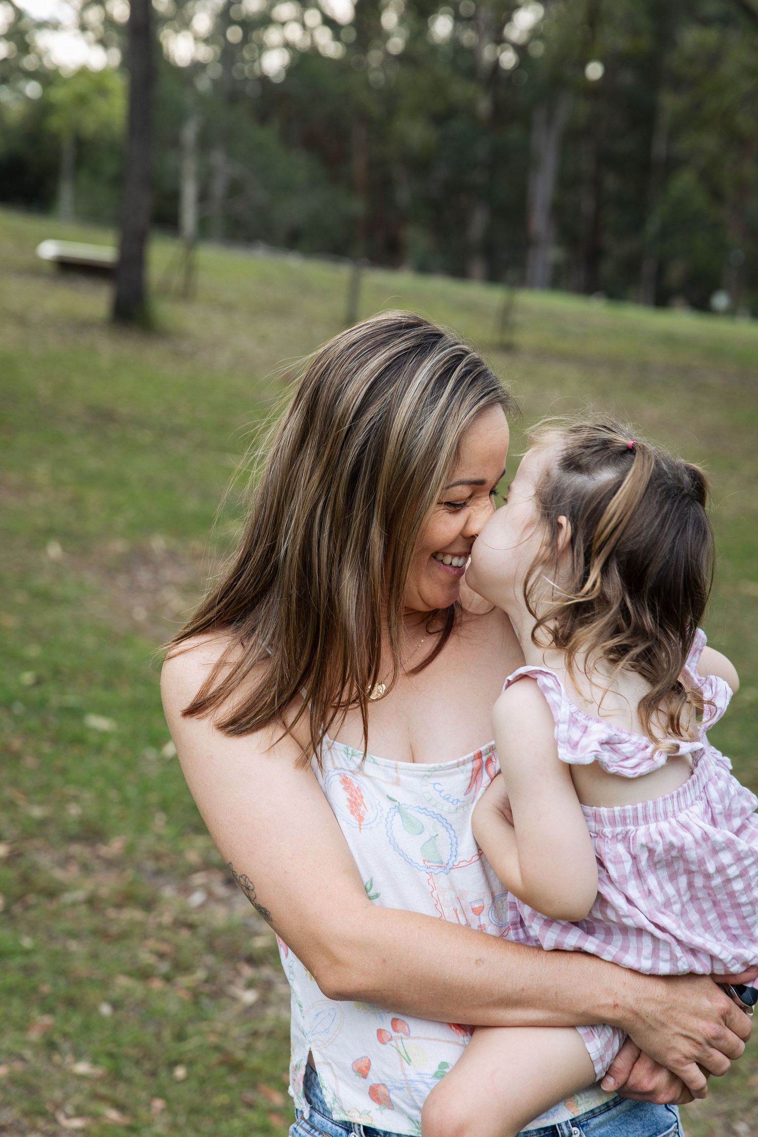 Sweet embraces and tender moments shared outdoors on a sunny day.