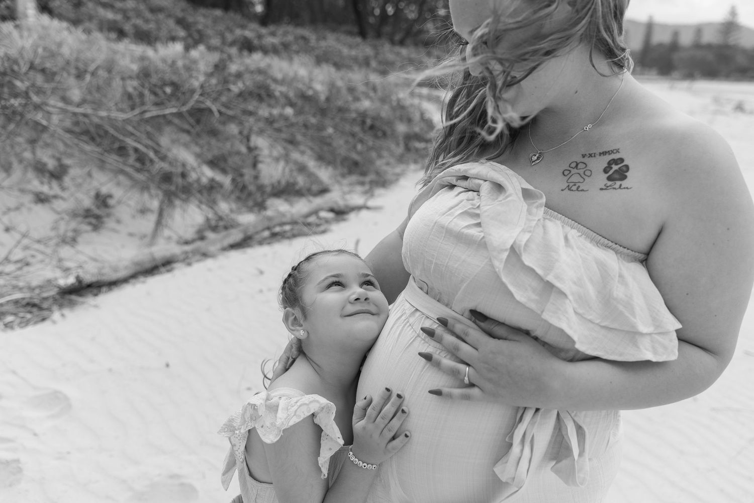 Black and white portraits capturing intimate moments between people in a natural setting.