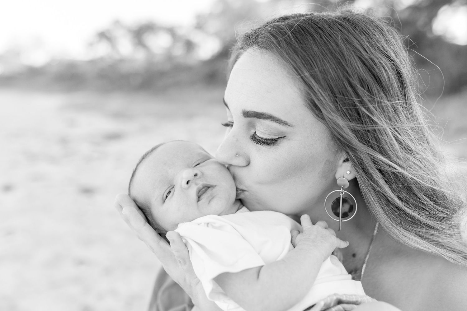 Coastal newborn session with family, featuring candid moments and gentle light.