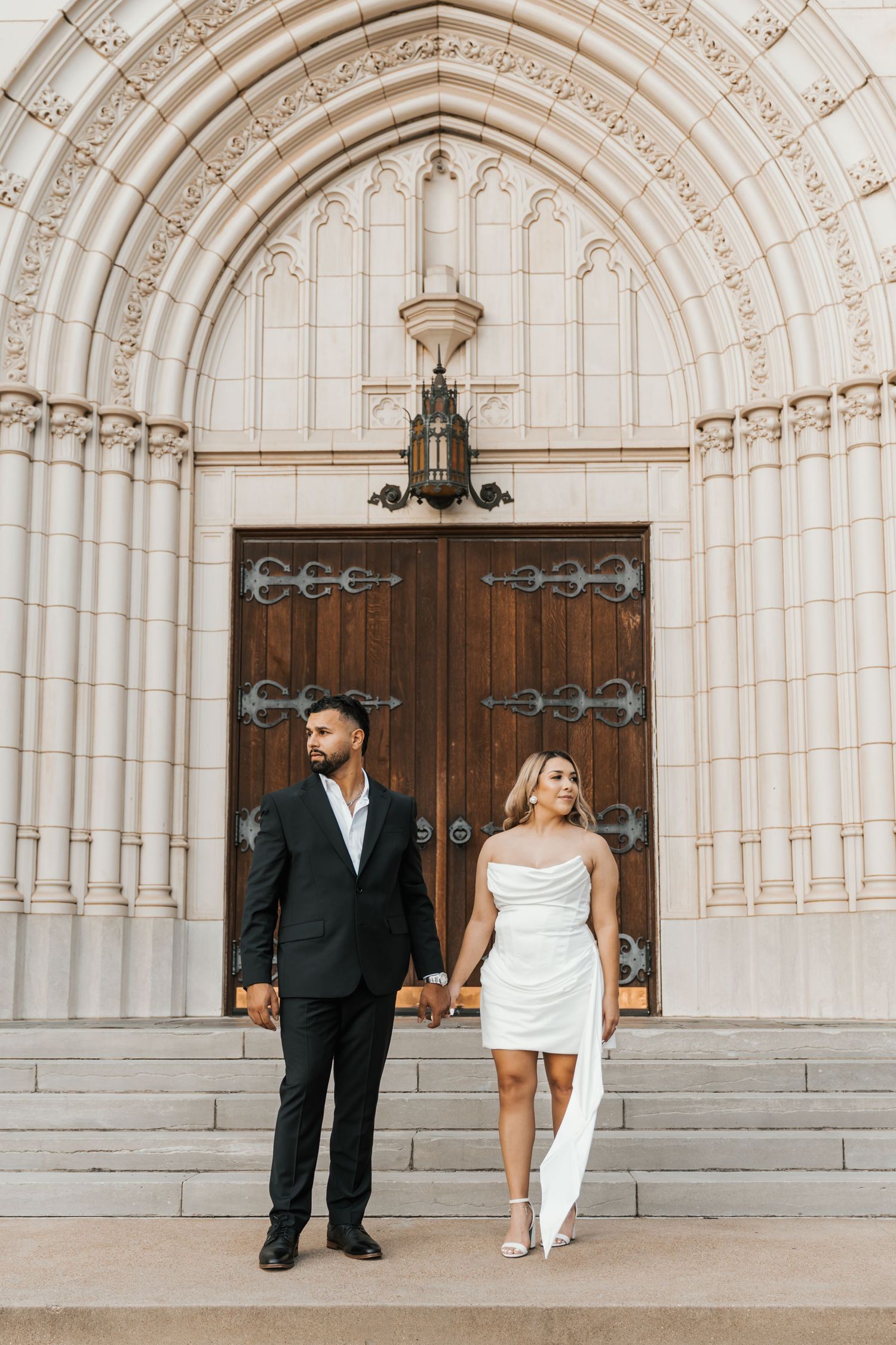 A wedding couple poses in front of ornate stone archways and wooden church doors in a series of artistic photos.