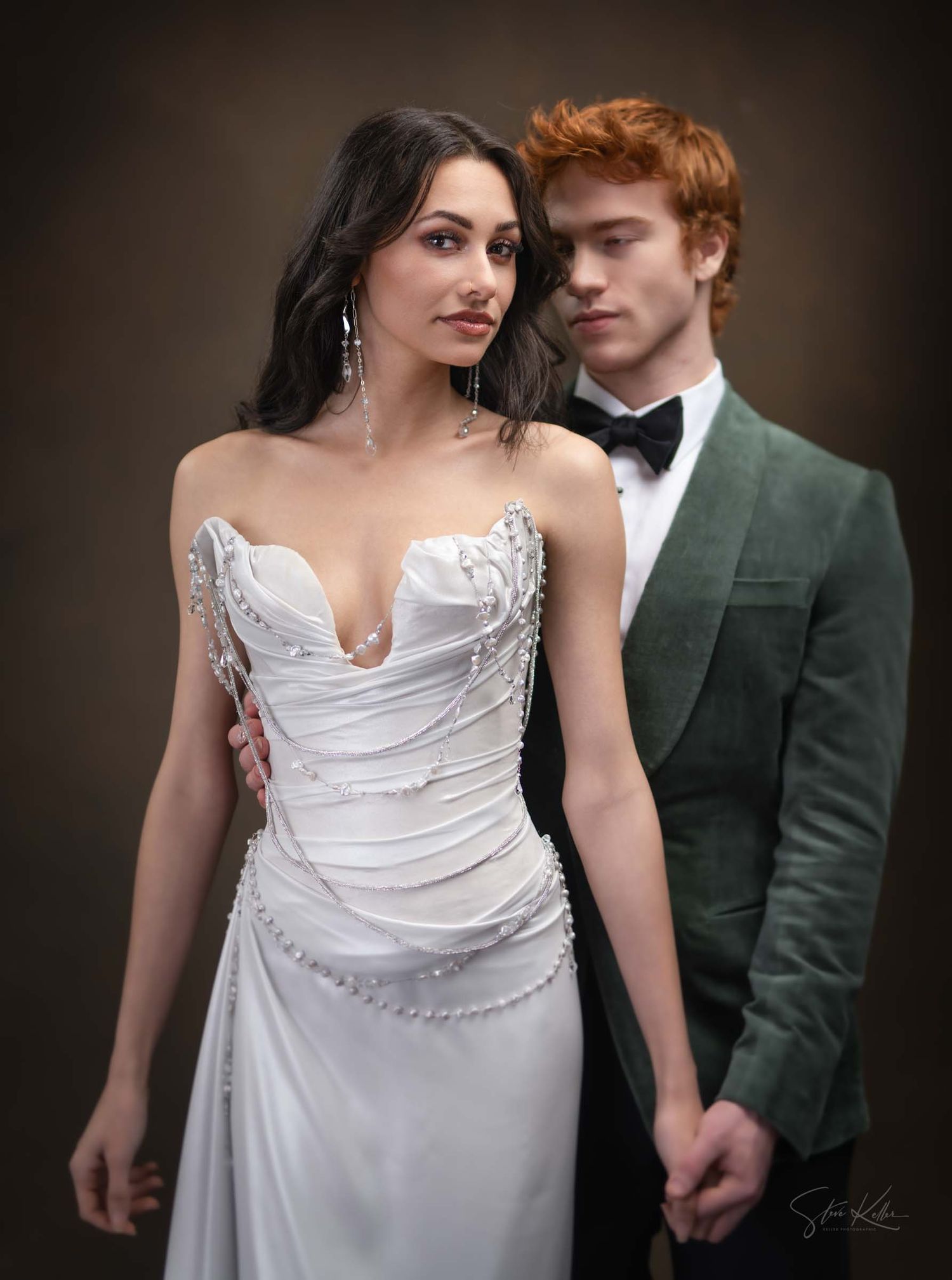 A couple in wedding attire, with the bride in white and groom in dark green suit, share intimate poses in romantic portraits.