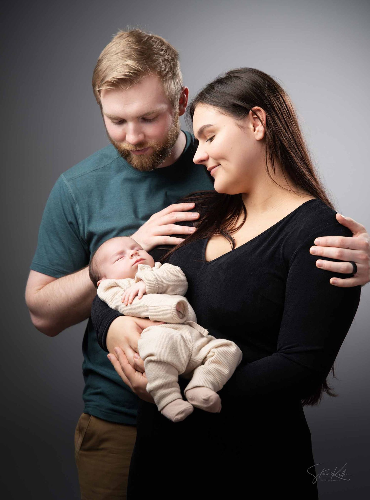 A series of intimate family moments showing parents bonding with their newborn baby against a dark studio backdrop.