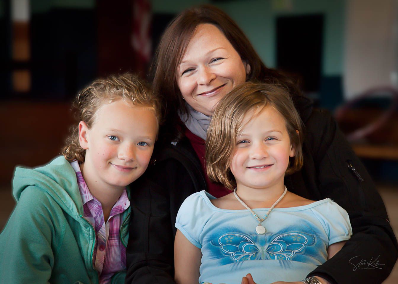 A series of five candid portraits showing children smiling and laughing in similar indoor settings.