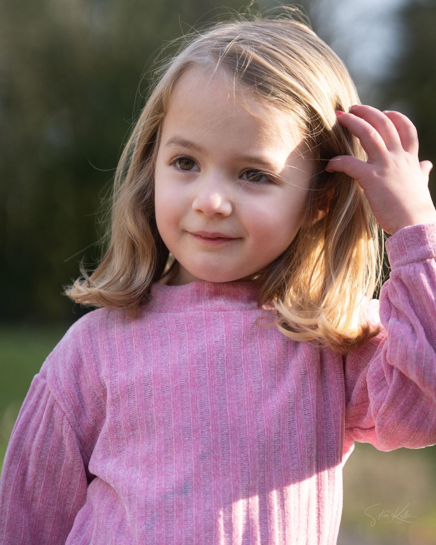 A child in a pink sweater poses playfully in a series of outdoor portrait shots.