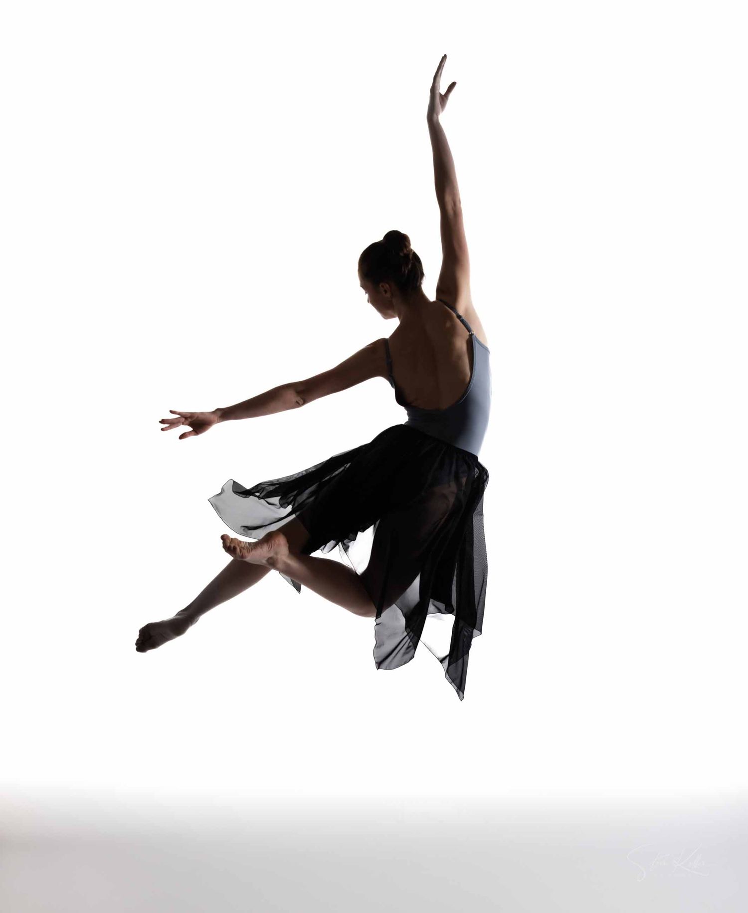 Graceful dancer in black leotard performs dynamic leaps and poses in a series of artistic dance movements.