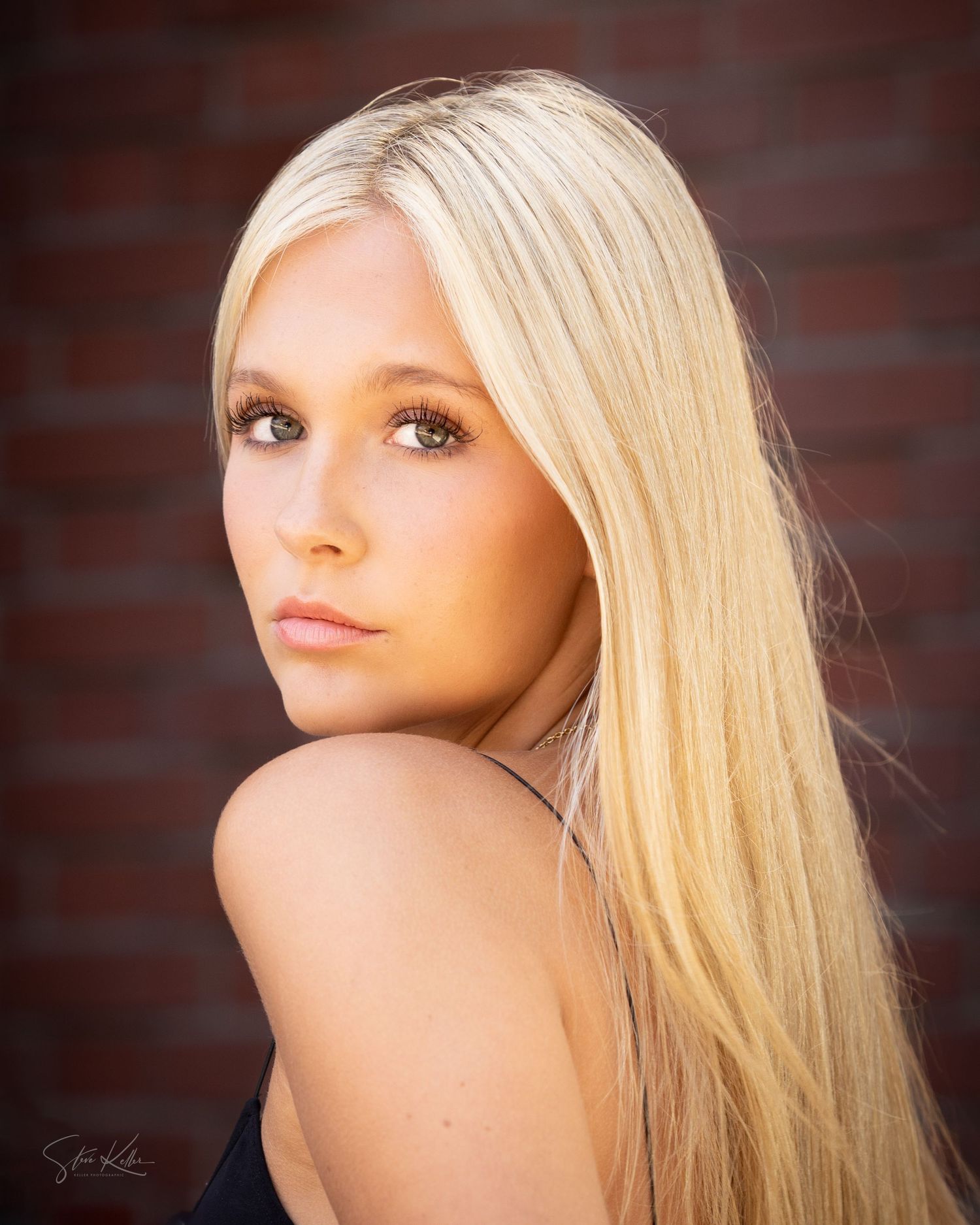 Classic beauty portrait with brick wall background.