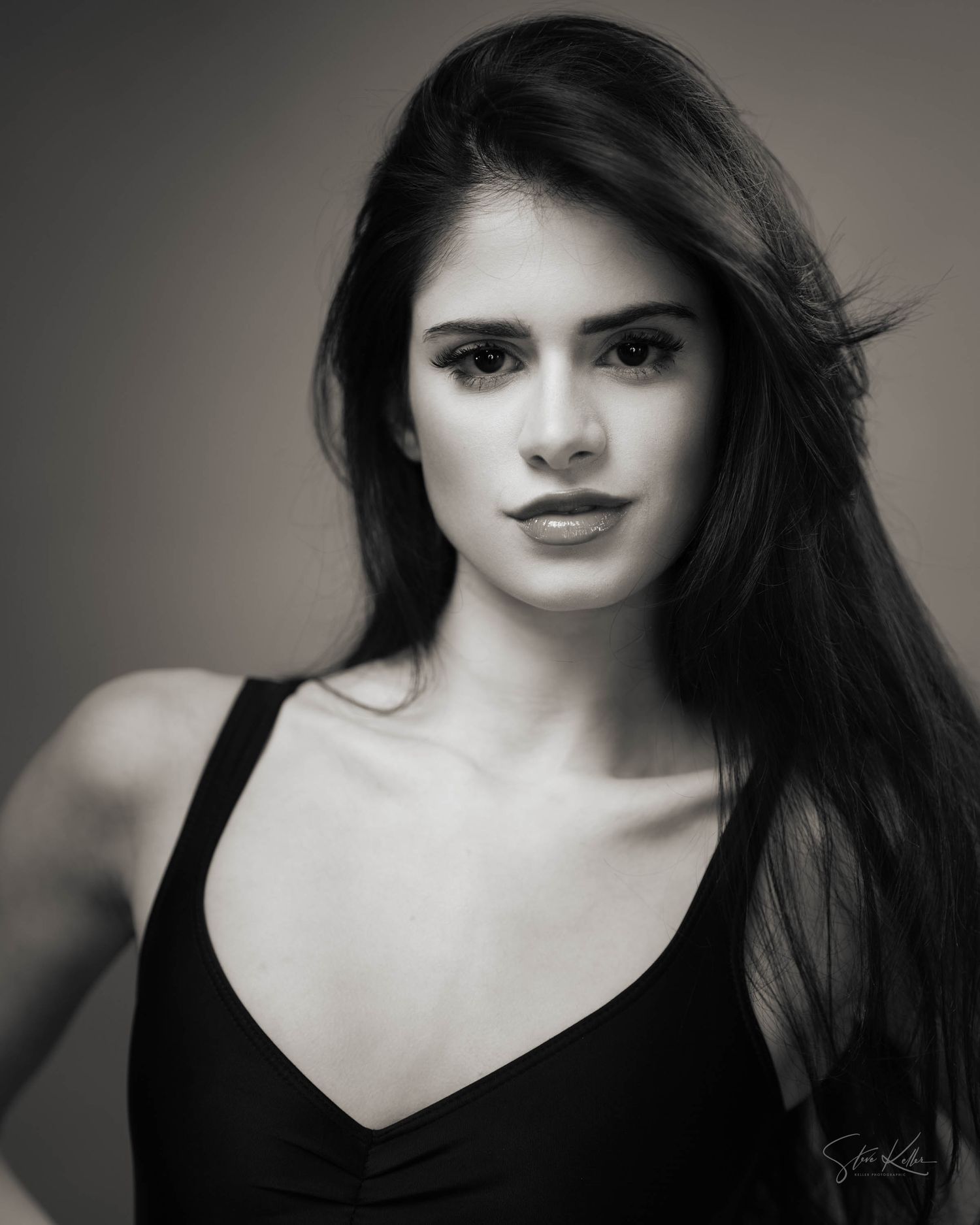 Classic black and white portrait featuring natural makeup and black tank top.