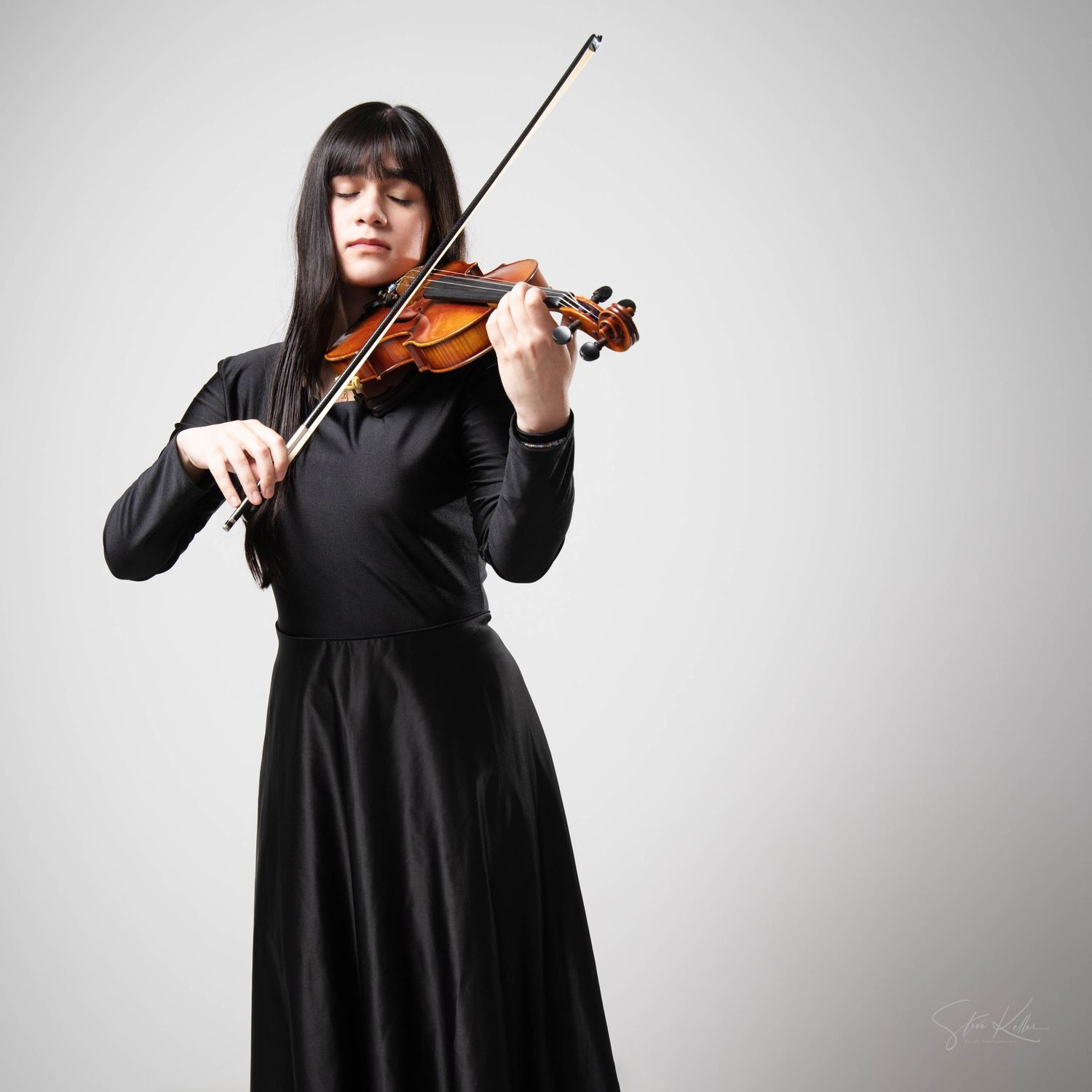 A violinist in black dress holds and plays a violin against a white background, shown in multiple poses.