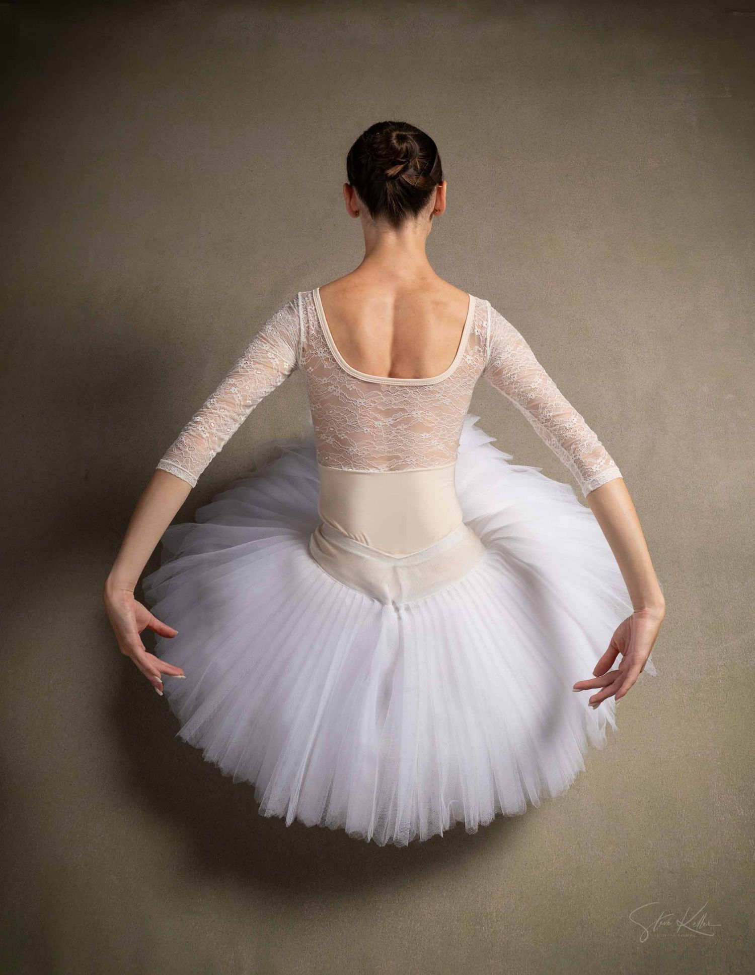 A ballet dancer in a white tutu and lace bodice shown in a sequence of poses against a dark background.