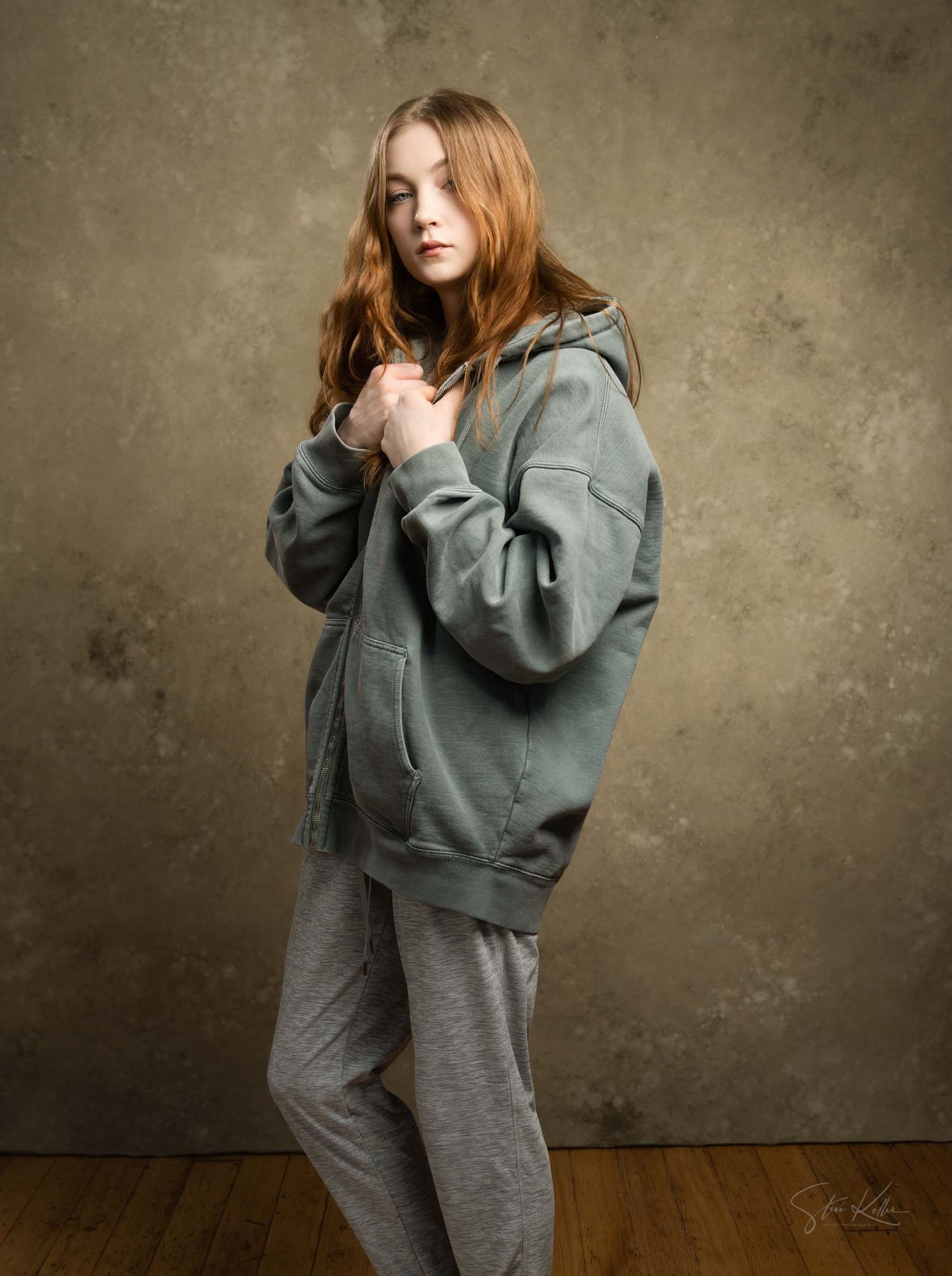 Lifestyle portrait series featuring comfortable grey sweatpants and oversized sage hoodie combination.