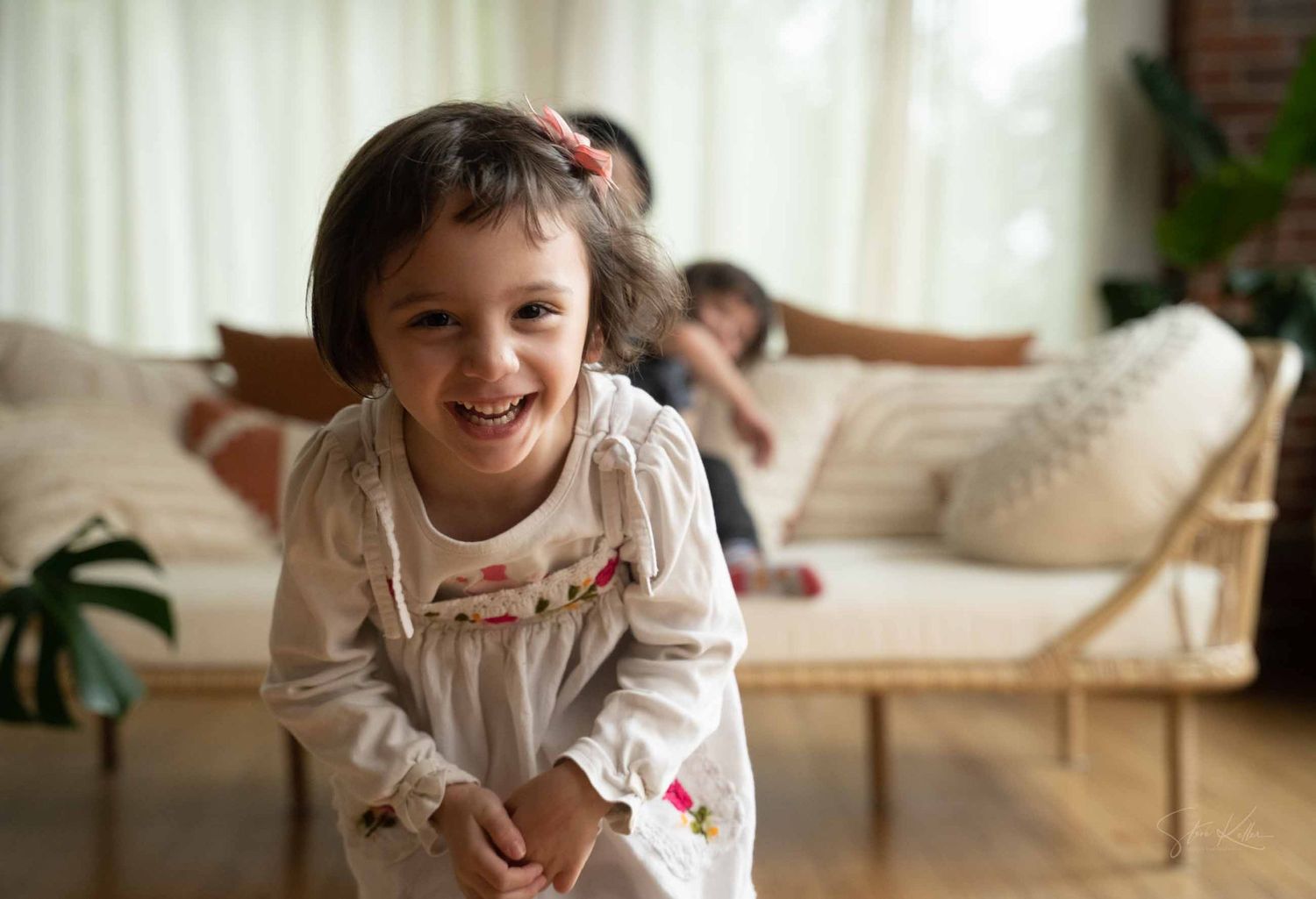 A series of candid photos showing joyful moments and laughter in a bright, sunlit living room interior.