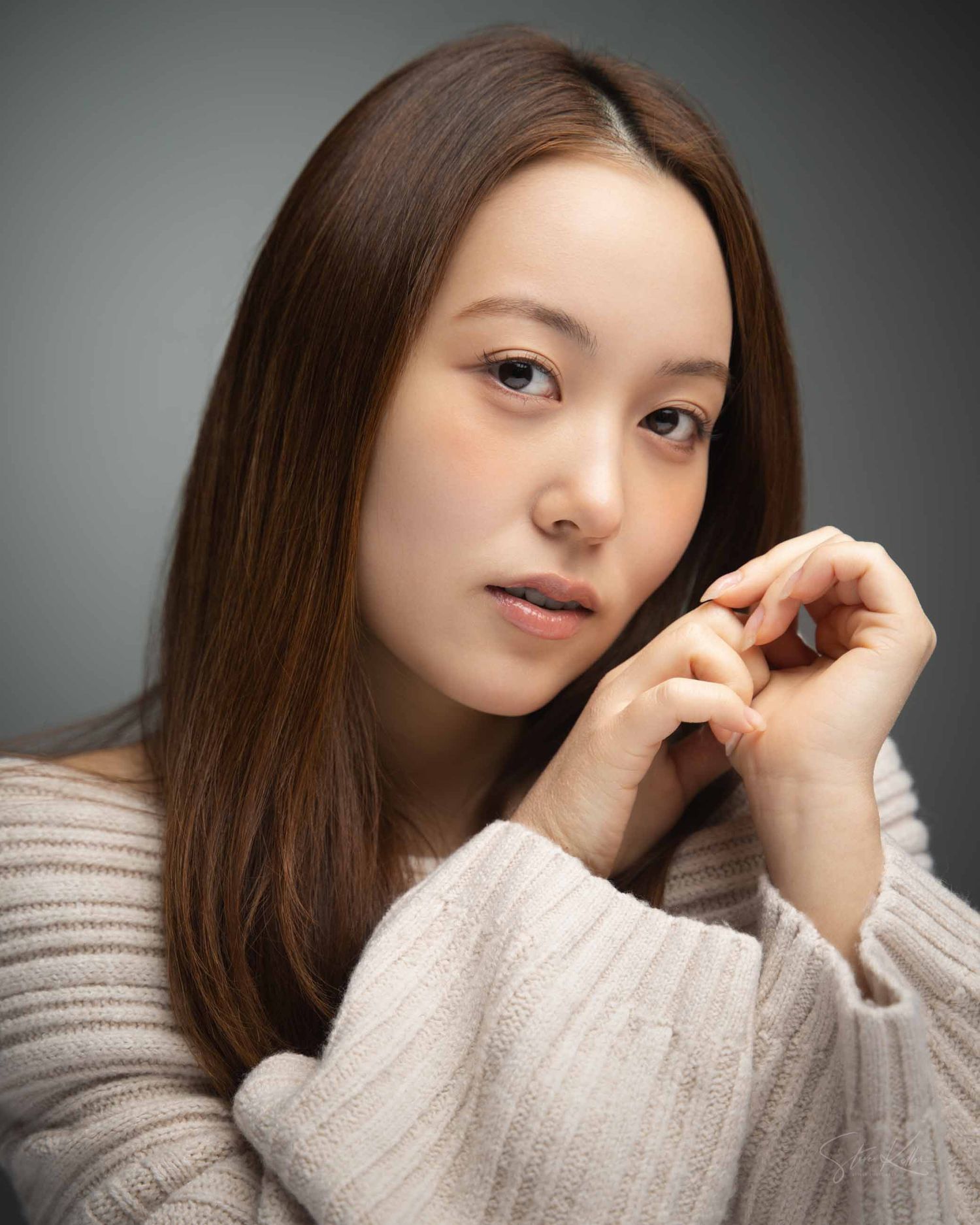 Portrait series showing a person in a cream sweater against a gray background with changing poses and expressions.