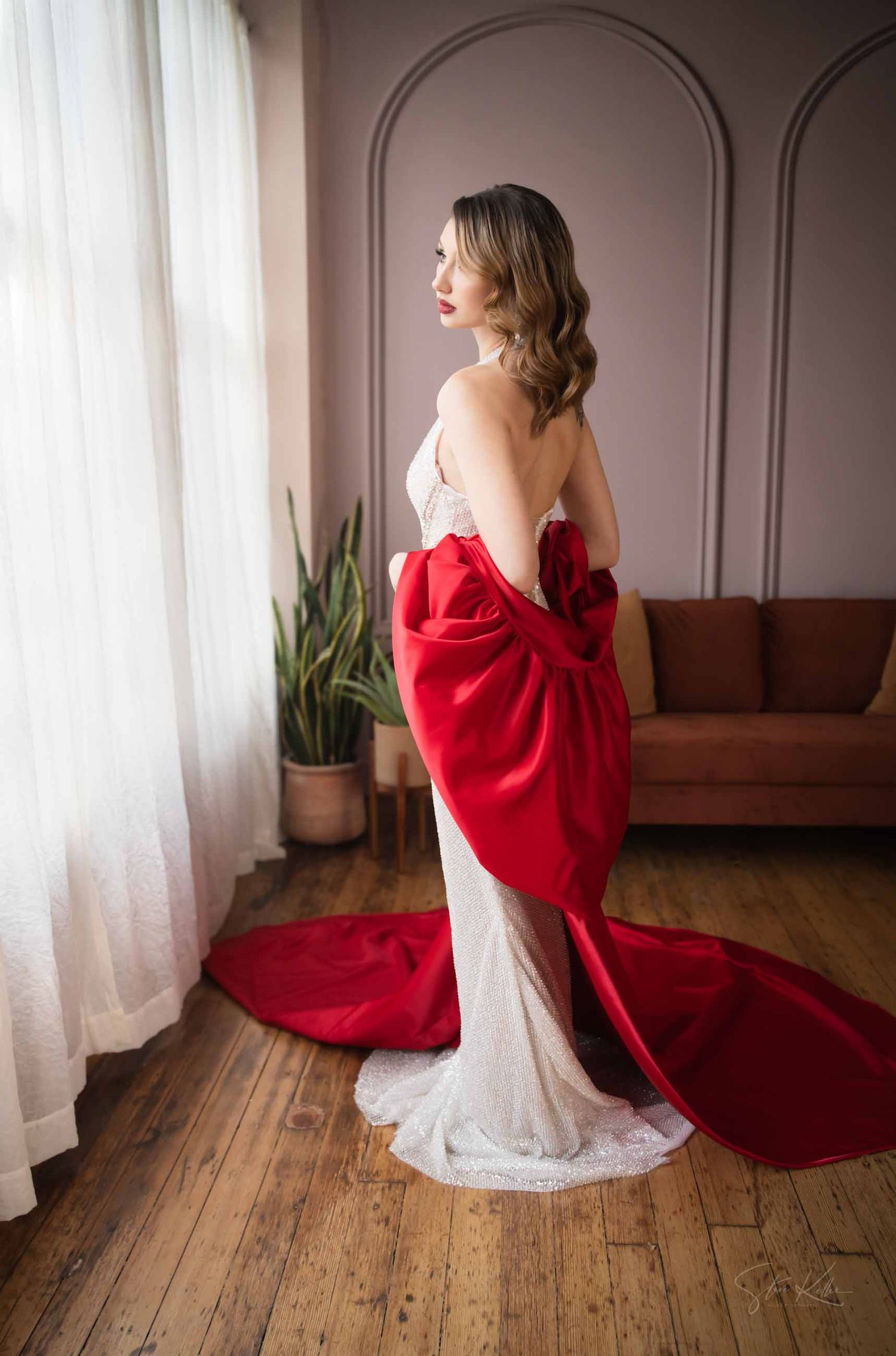 A series of artistic portraits featuring a red dress against white curtains and wooden floors in a minimalist setting.