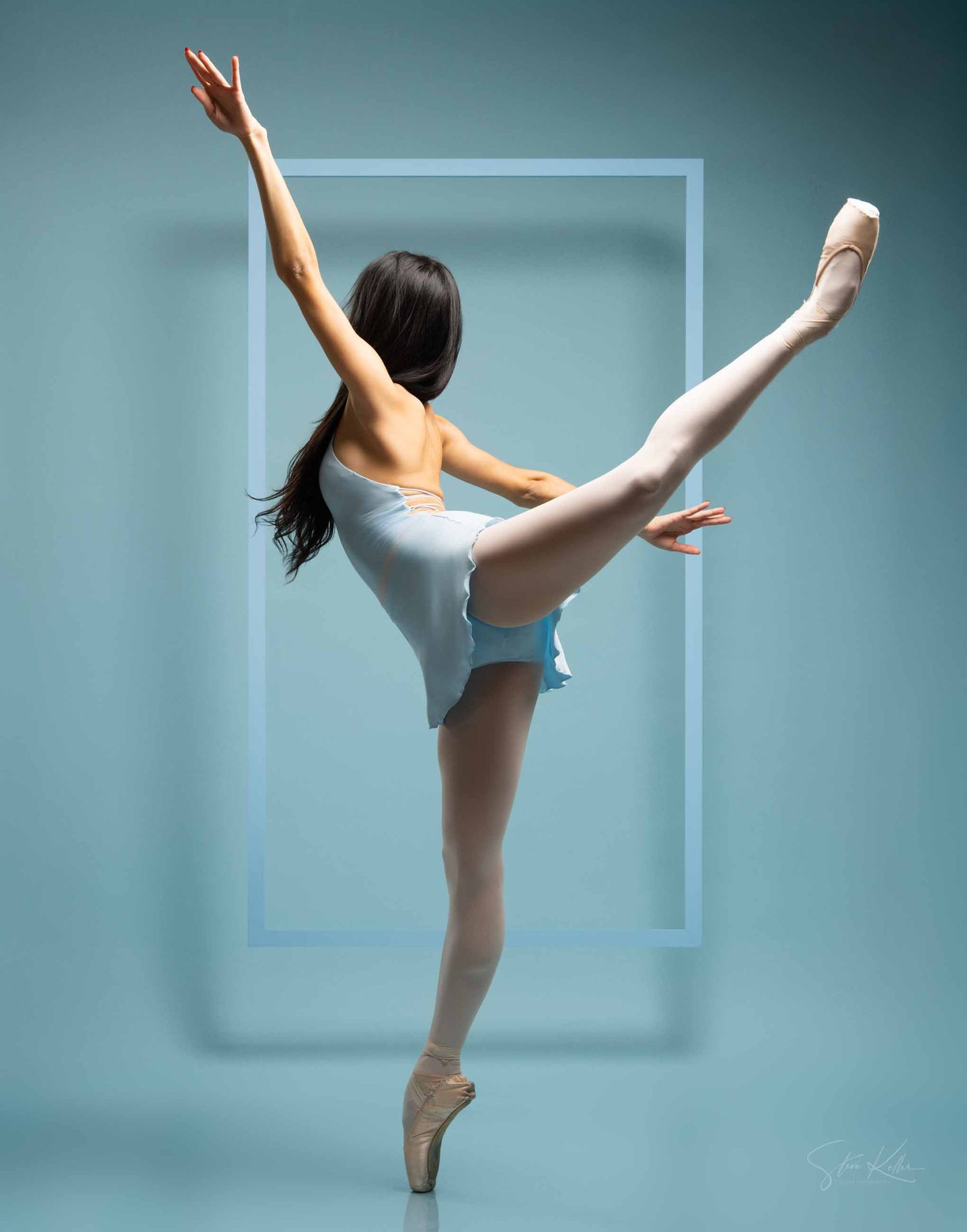 Ballet dancer in white leotard performs graceful poses against turquoise studio backdrop.