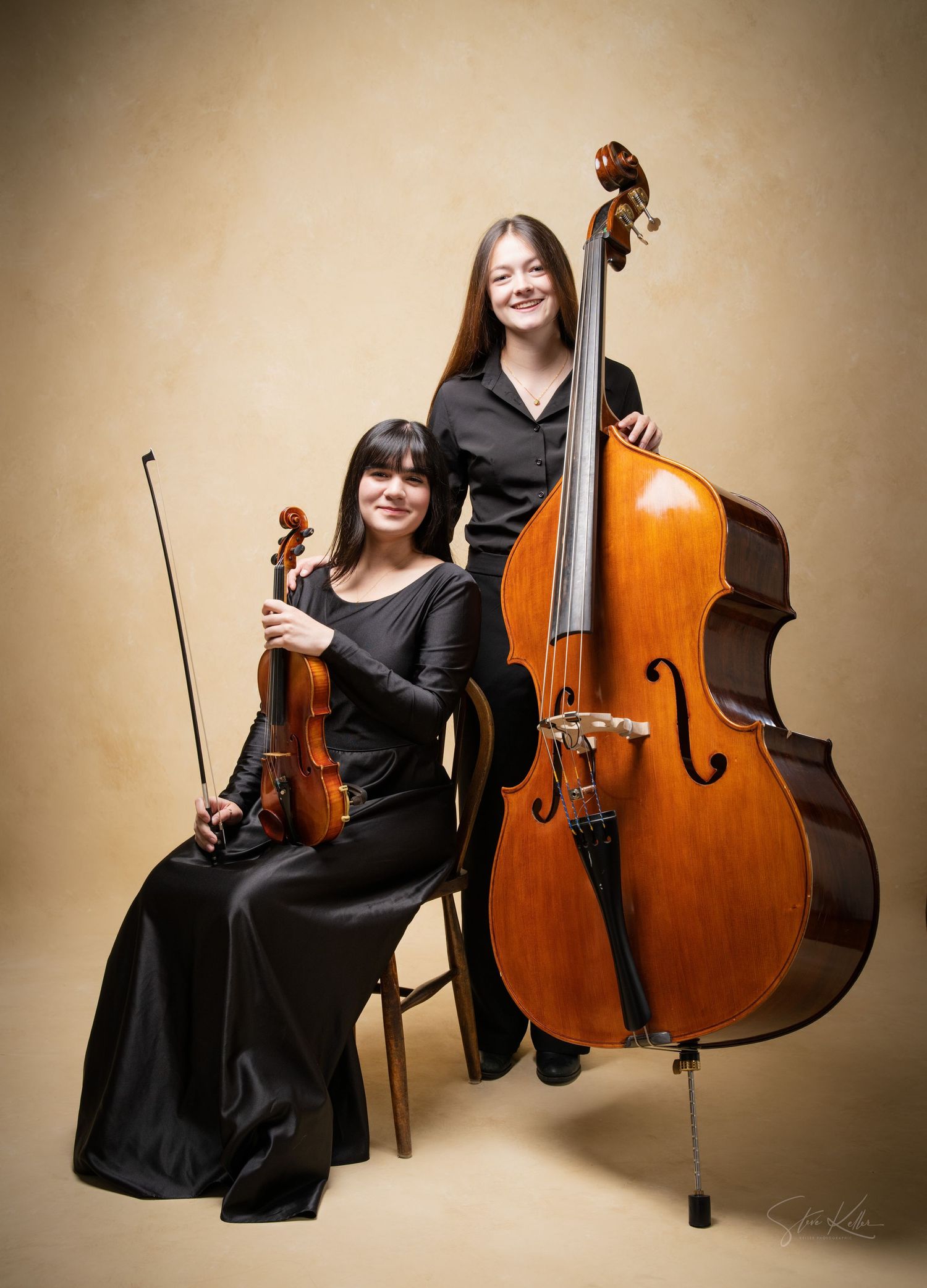 Professional musician in black formal wear poses with string instruments in multiple artistic studio portraits.