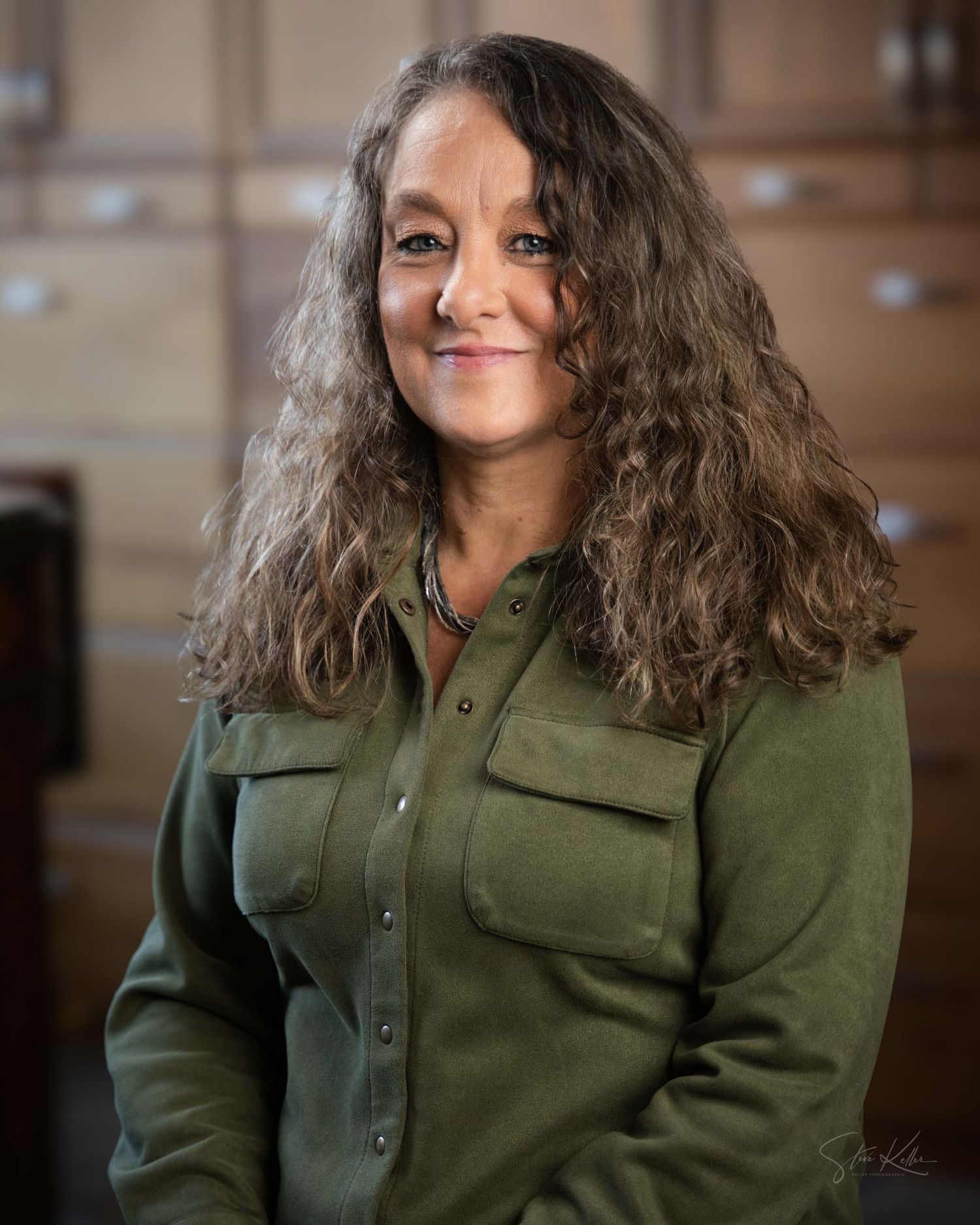 A series of headshots showing a person with curly brown hair wearing an olive green button-up shirt against a blurred background.