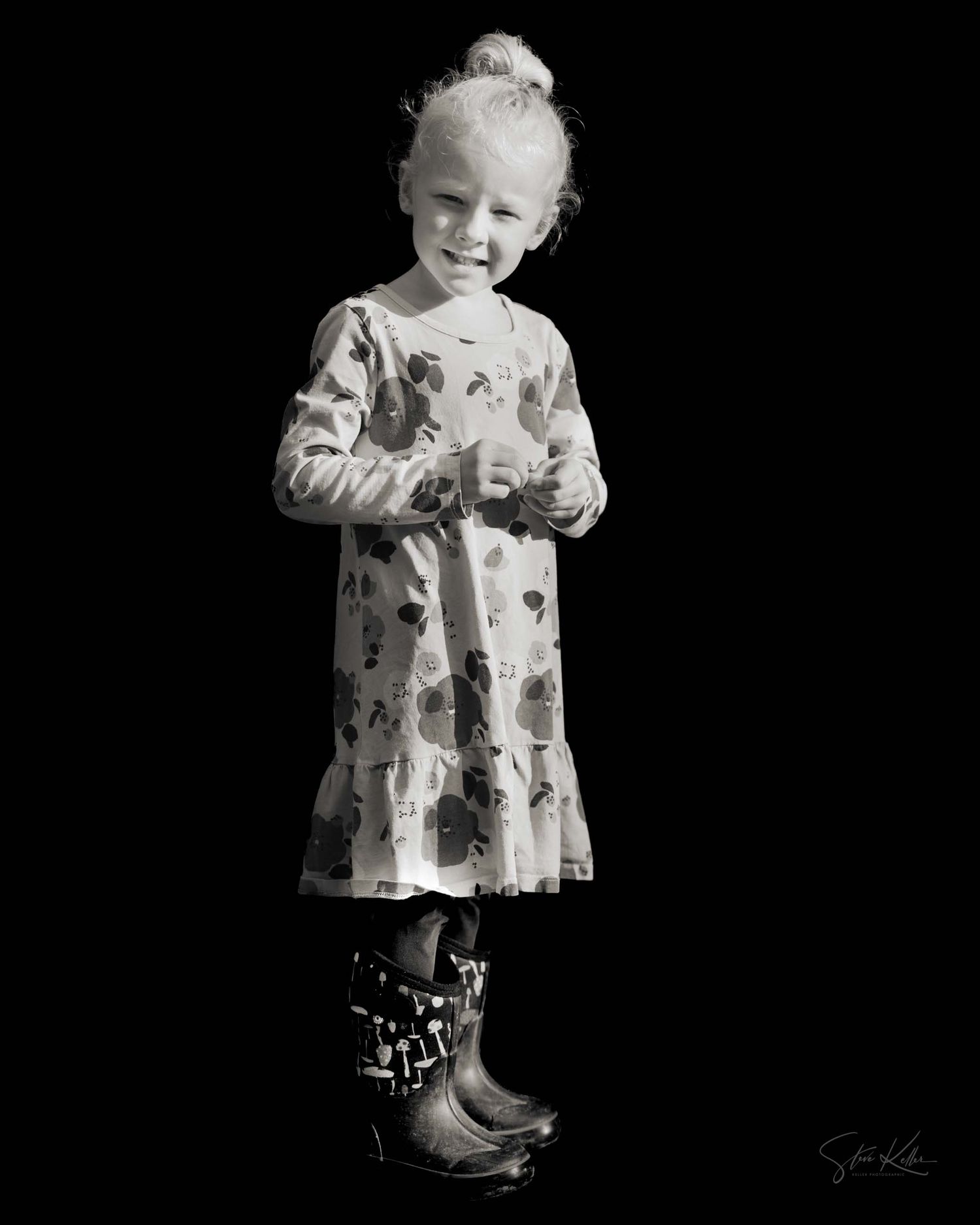 Black and white artistic portraits showing a floral dress and playful poses against a dark backdrop.