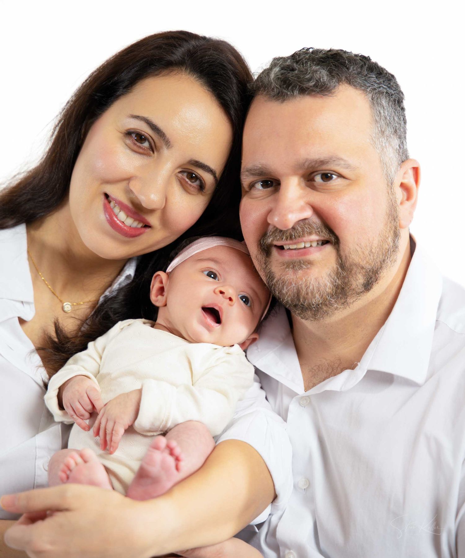 A series of intimate family portraits showing tender moments between parents and their newborn baby.
