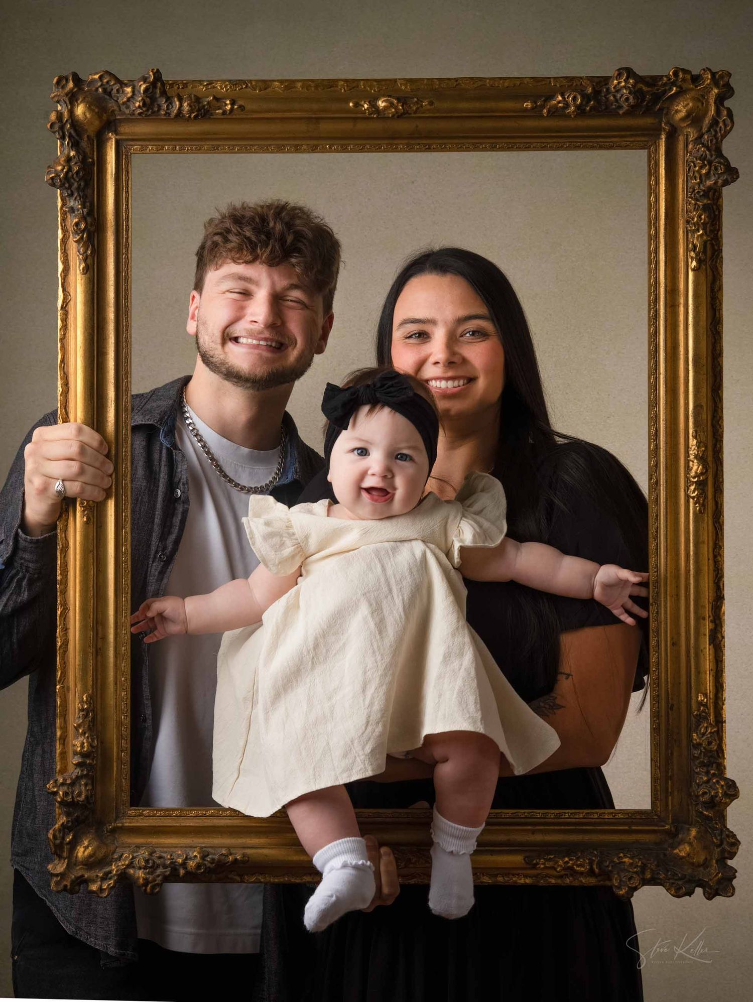 A family poses playfully through a series of vintage gold frames in a creative photo collage.