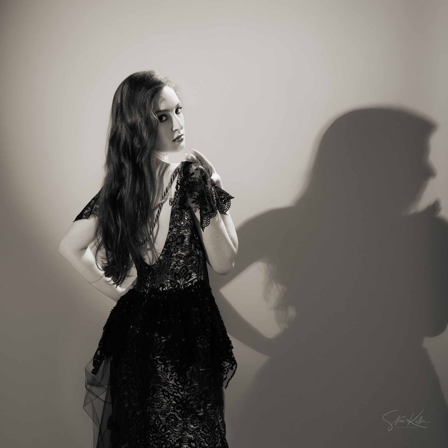 Dramatic black and white portrait series showing a person in dark clothing against a wall with strong shadow effects.