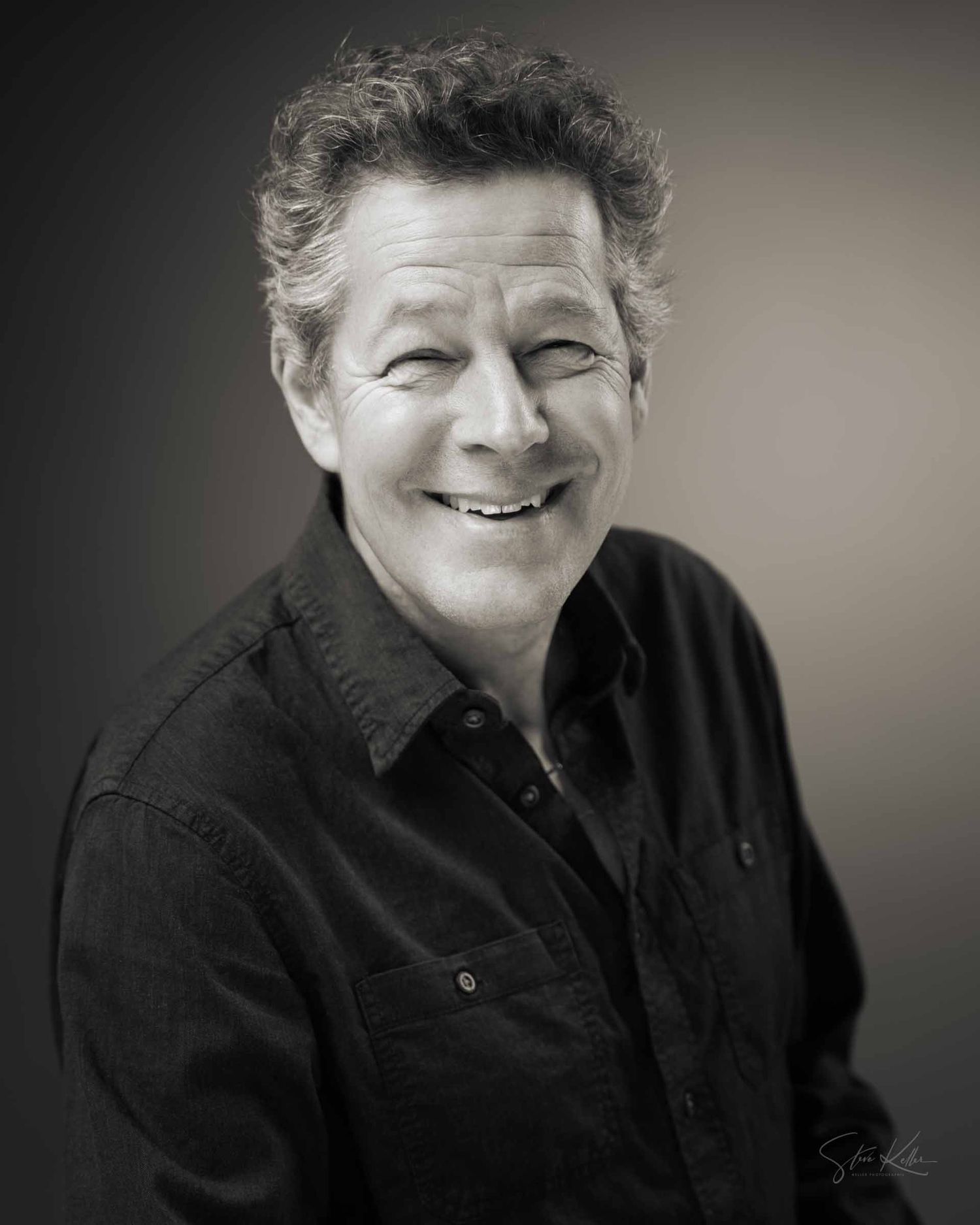 A series of black and white portraits showing someone wearing dark clothing with a soft, expressive smile.