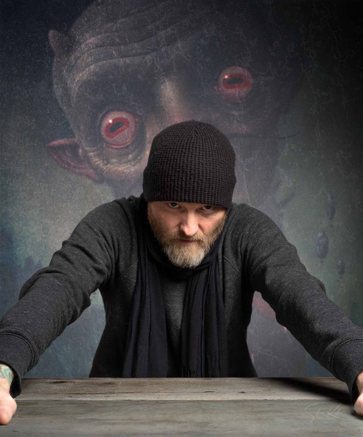 Dark surreal portrait of someone in black winter clothing with large red glowing eyes looming in the misty background.