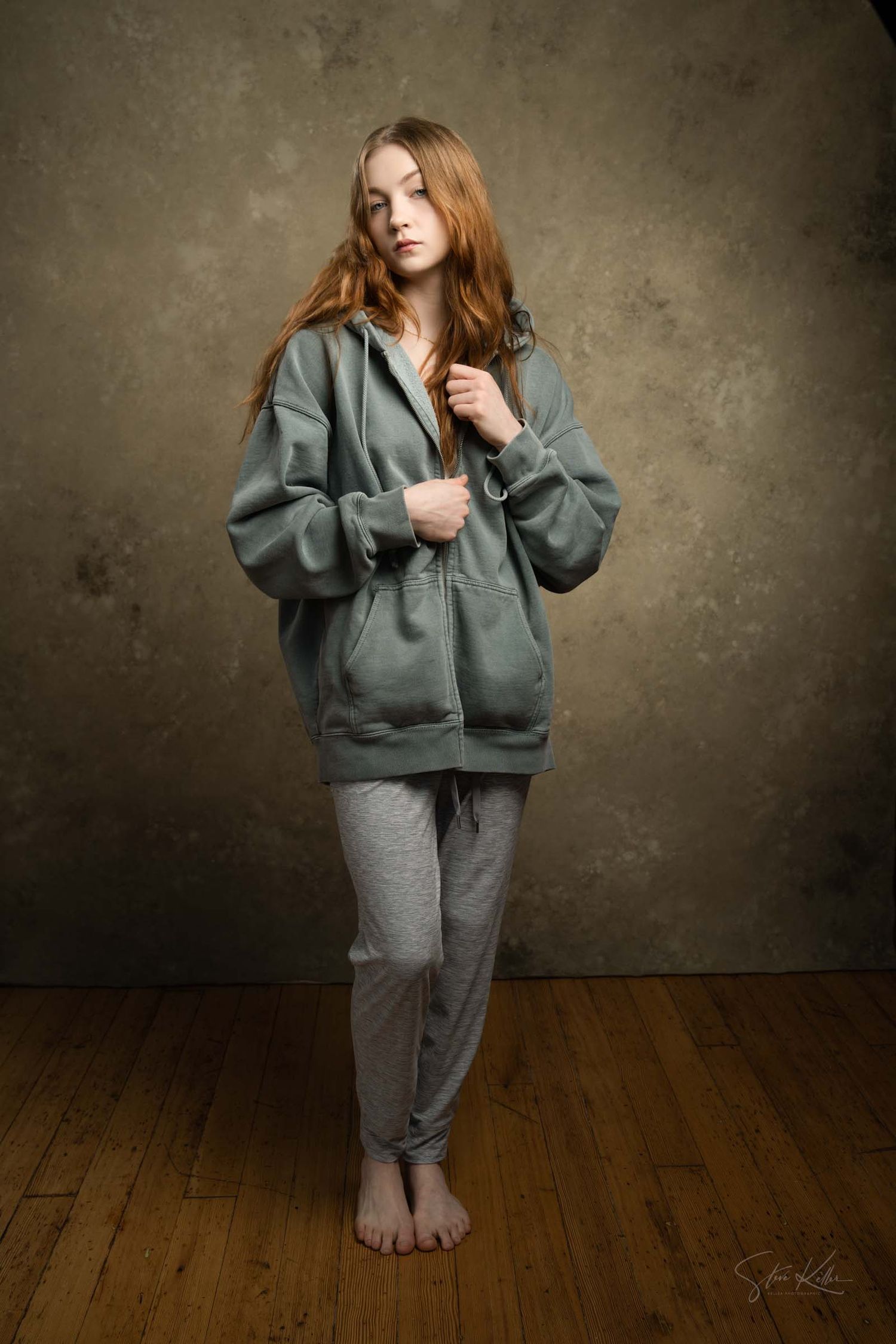 Artistic fashion sequence showcasing cozy athleisure wear on wooden floor with moody lighting.