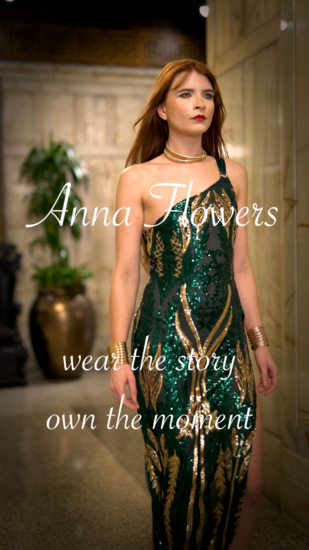 Elegant emerald green and gold sequined evening gown with side slit photographed in luxurious hallway setting.