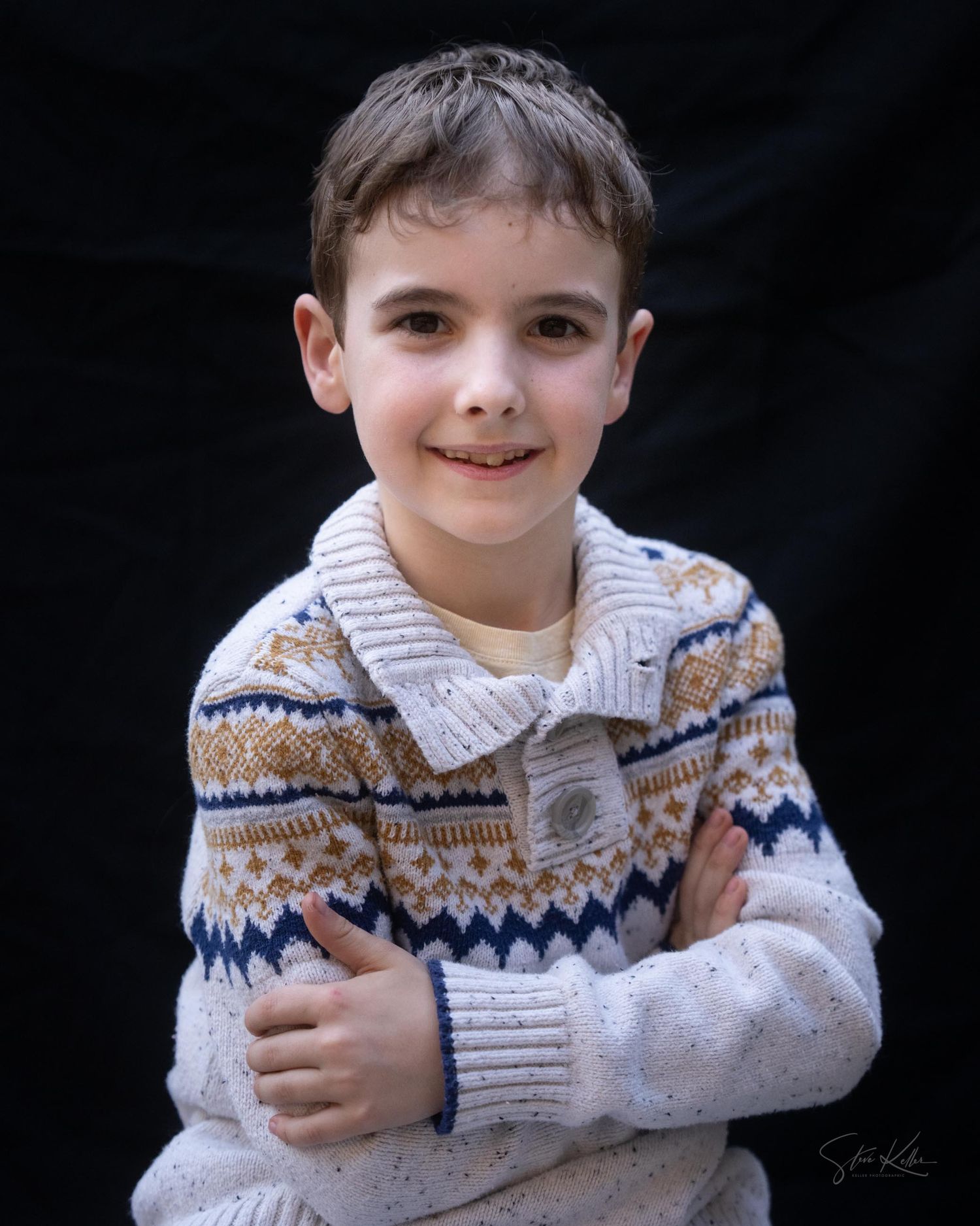 A child wearing a white and brown patterned sweater poses against a dark background in a series of candid shots.
