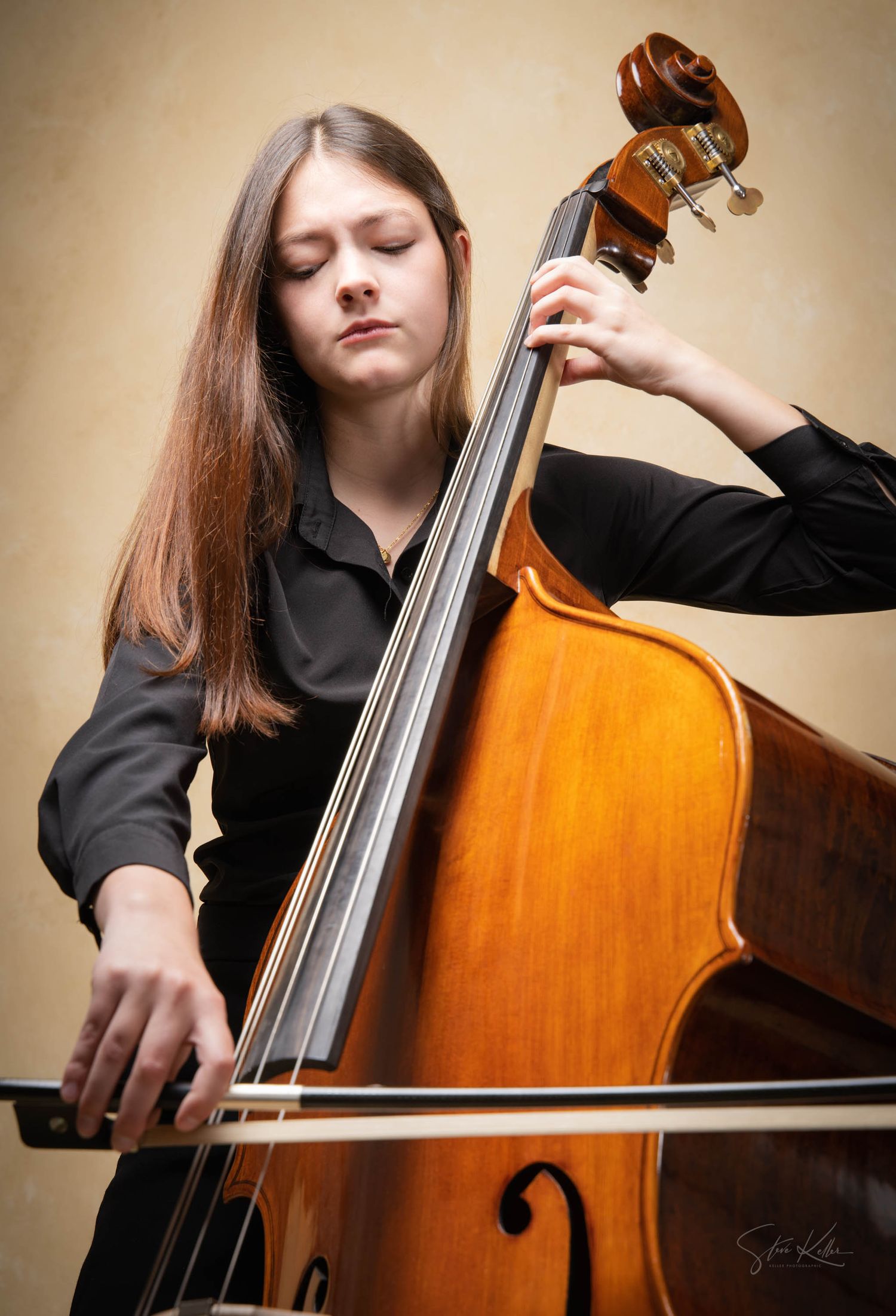 A musician plays a double bass in a sequence of close-up shots showing different angles and techniques on the wooden instrument.