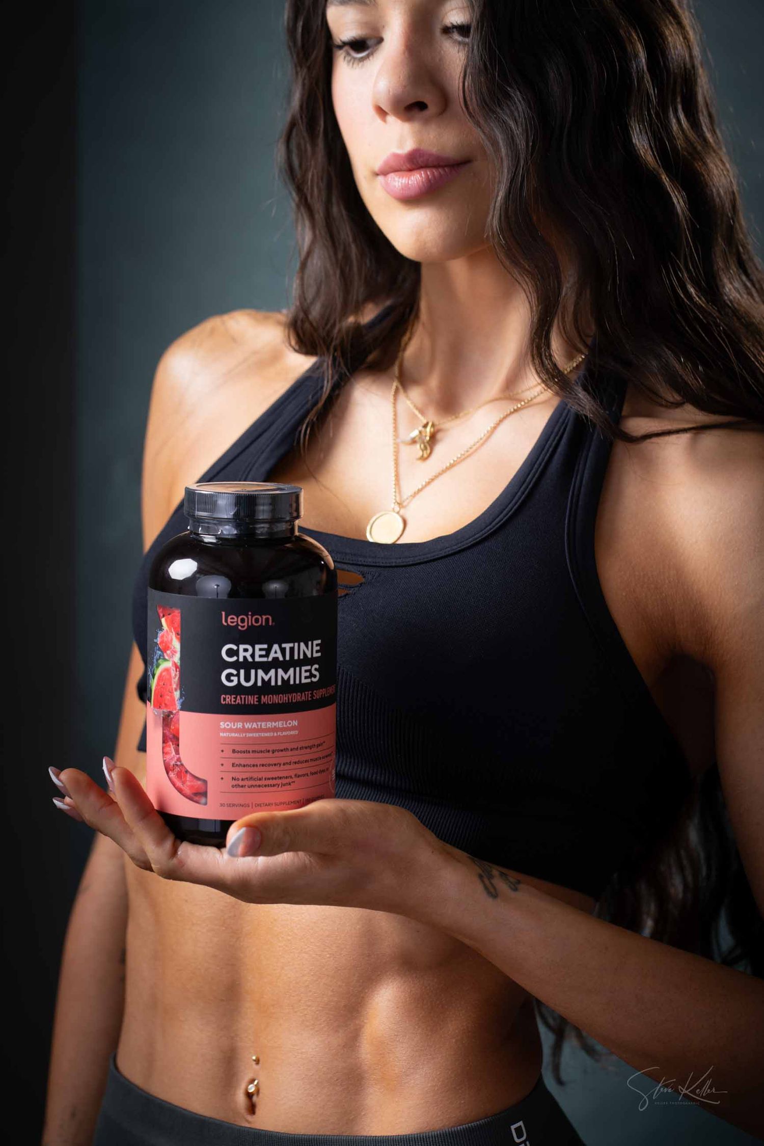 Product photography showing fitness supplements and workout attire in moody lighting.