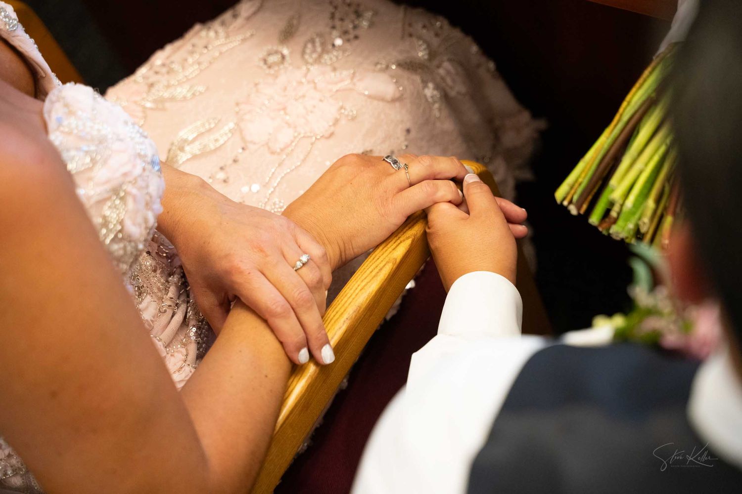 Close-up of bride and groom exchanging rings during a wedding ceremony, showcasing the wedding bands.