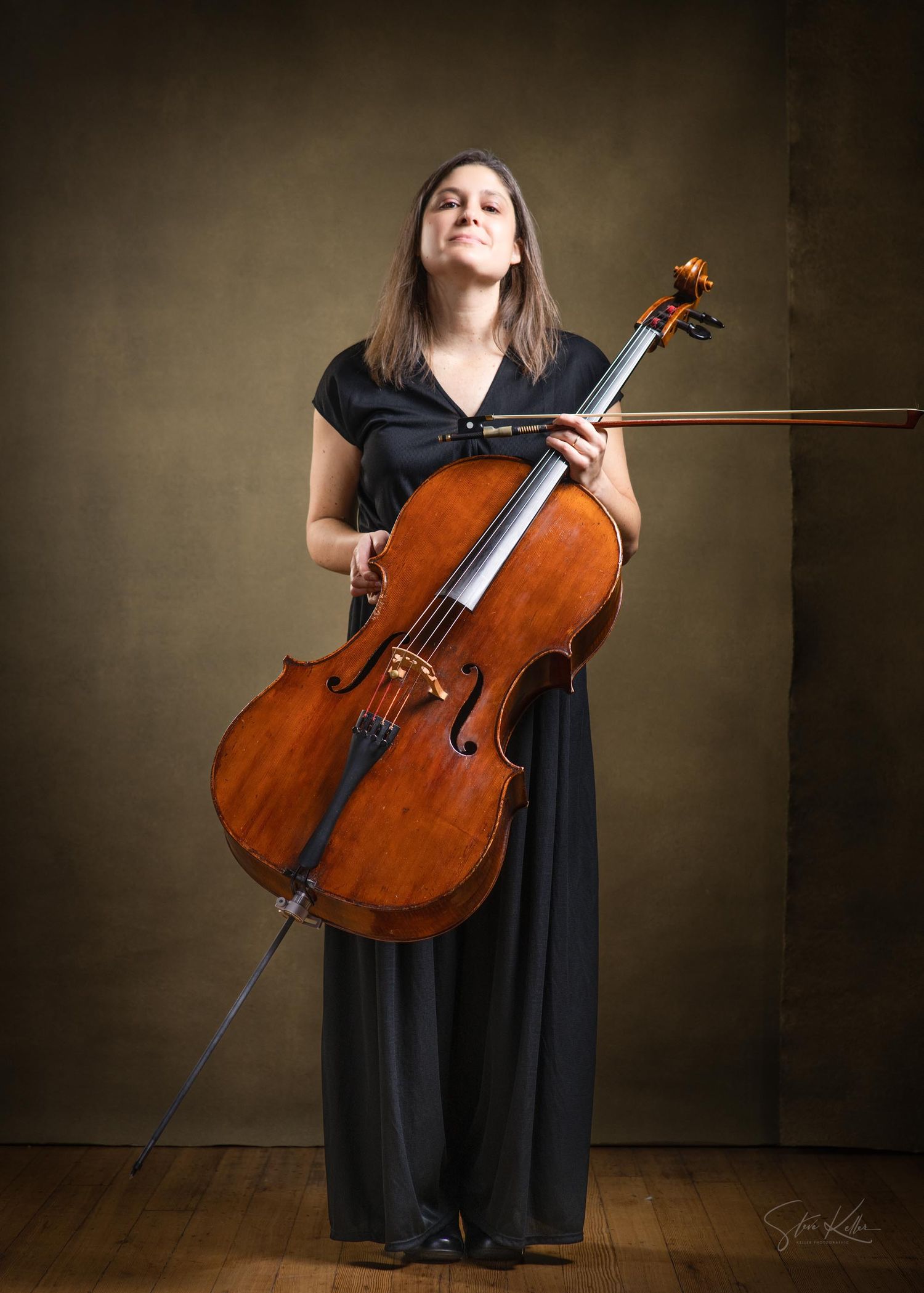 A musician in a black dress poses with a cello in a series of artistic studio portraits against a dark background.