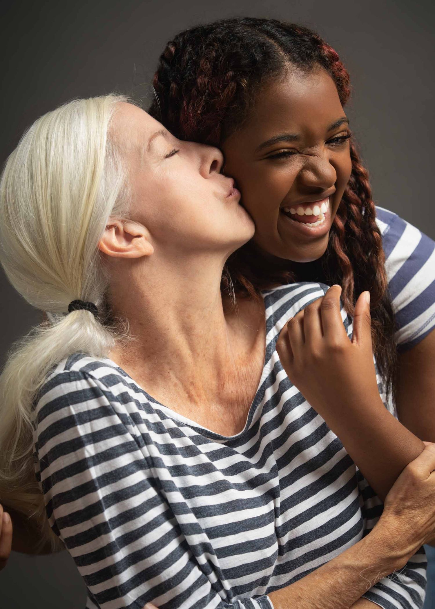 Two people in matching striped shirts share joyful laughter and intimate moments in a series of candid photos.