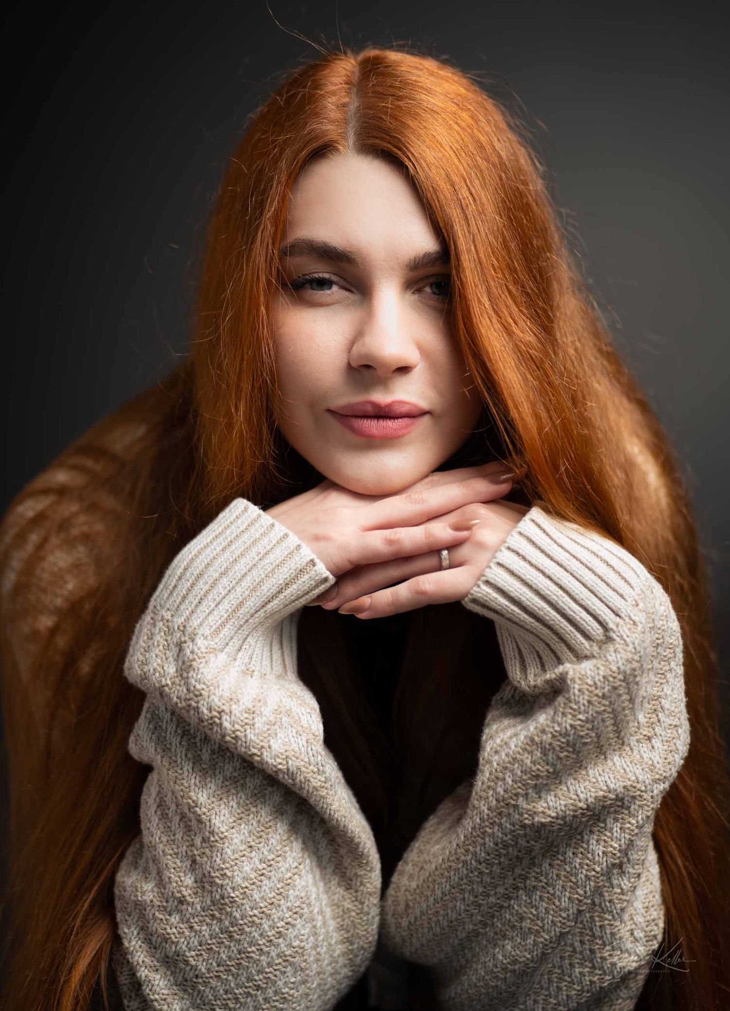 A series of portrait shots showing long red hair and cream-colored knit sweater sleeves against a dark background.