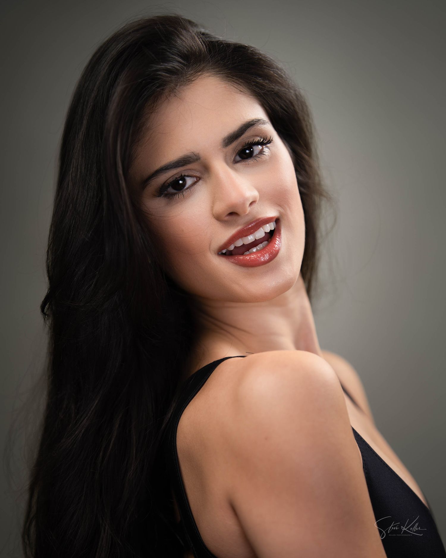 Glamour beauty portrait with professional makeup and long dark hair.